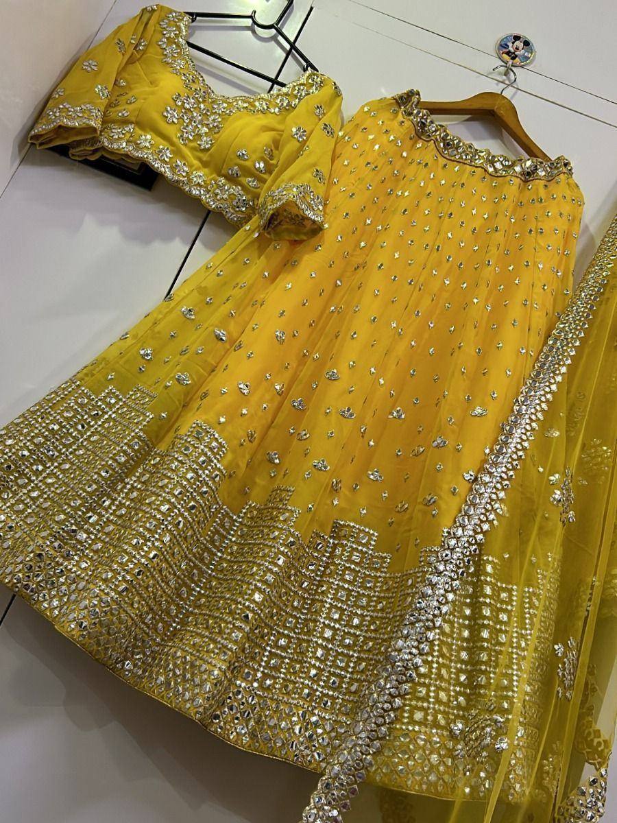 Yellow designer lehenga choli with heavy silver embroidery and mirror work, perfect for weddings and festivals