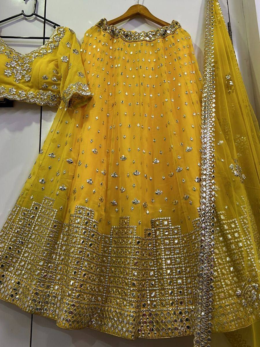 Yellow designer lehenga choli with mirror work and embroidery, perfect for Indian ethnic occasions