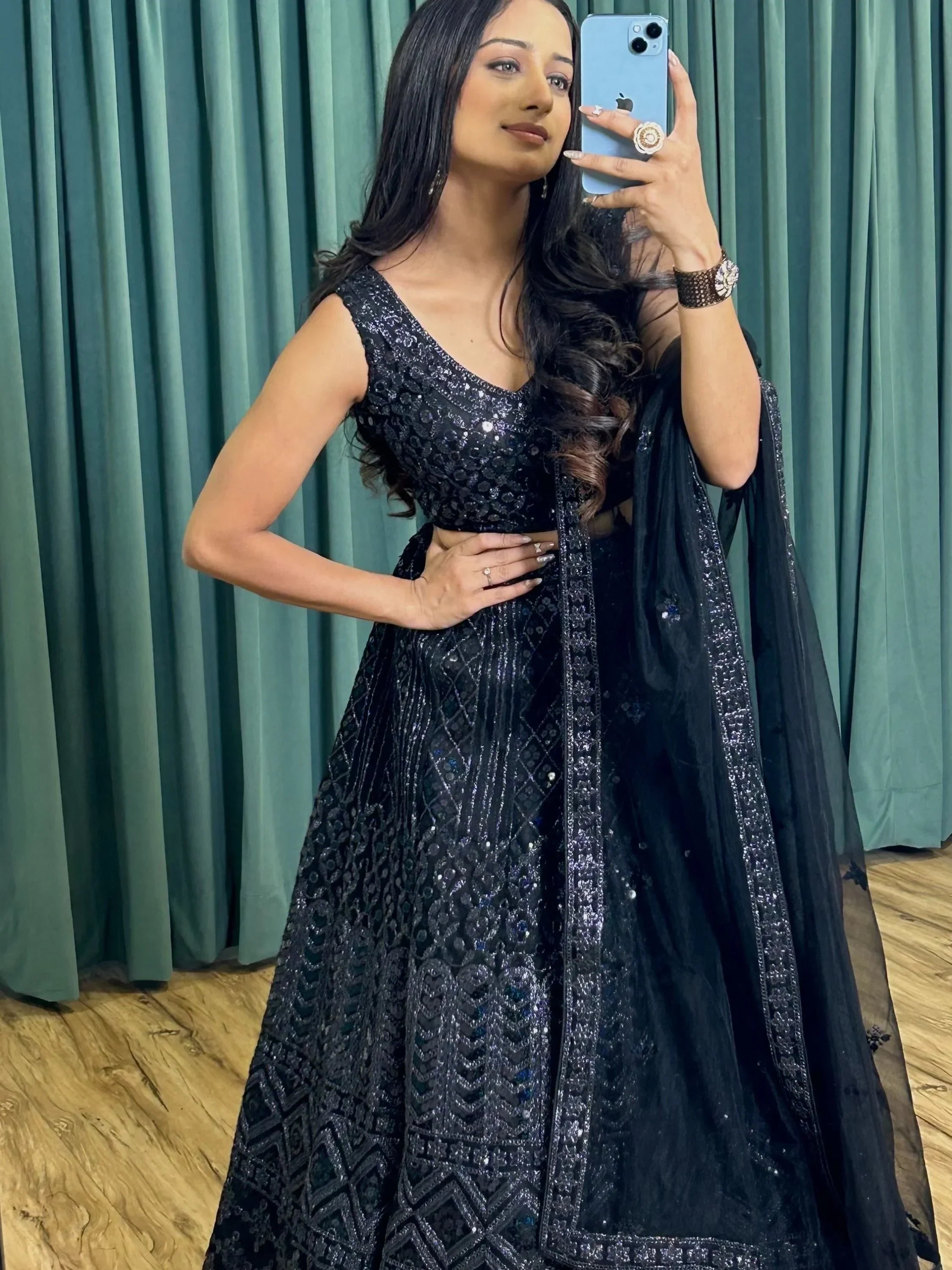Black sequined lehenga choli with sheer dupatta, perfect for Indian ethnic occasions and festive wear.