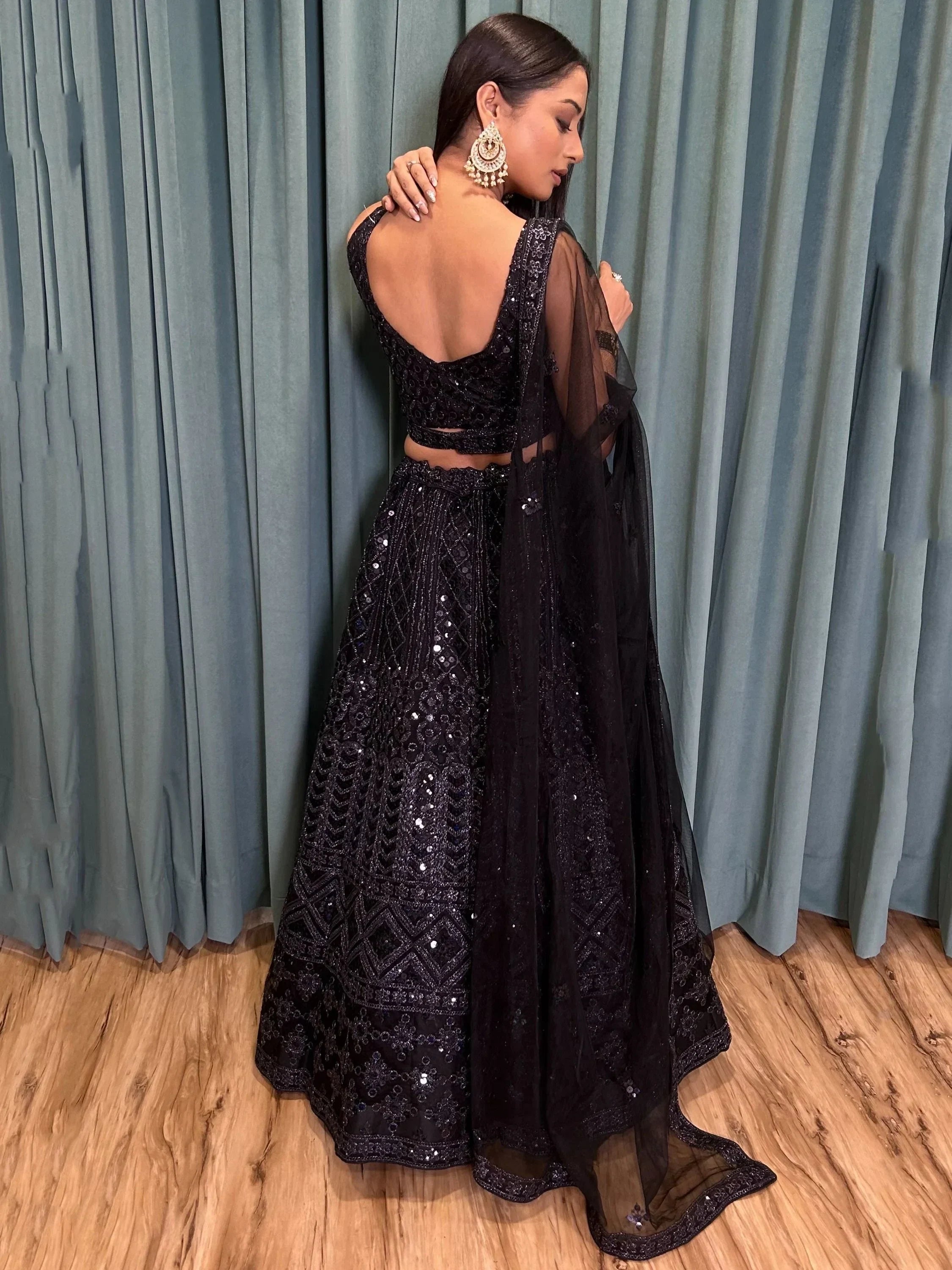Black sequined lehenga choli with sheer dupatta, backless designer ethnic wear for women