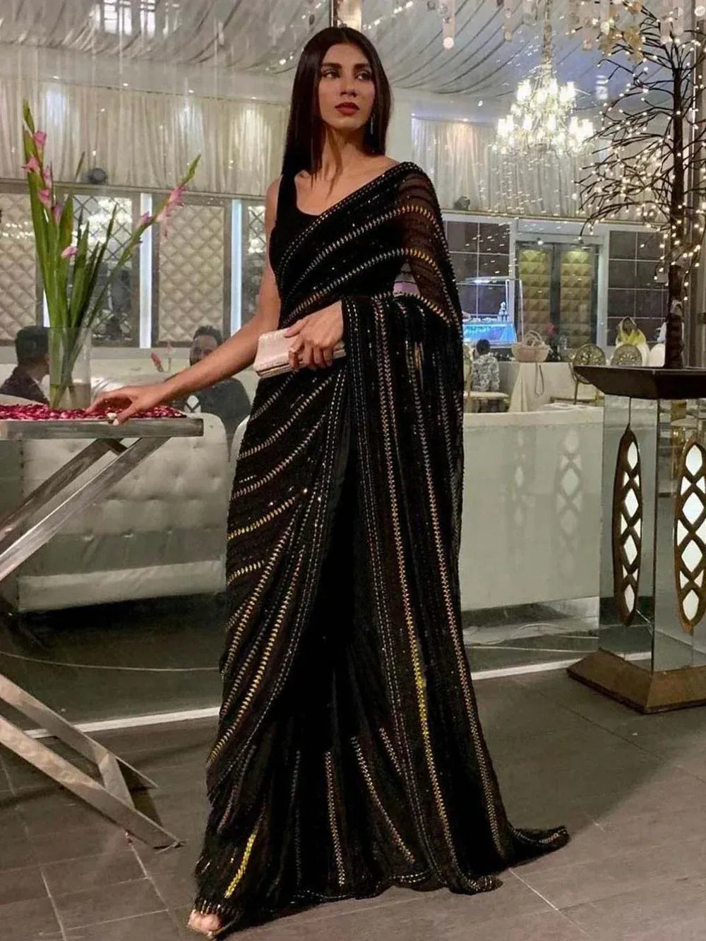 Elegant black saree with golden stripes, perfect for ethnic wear events
