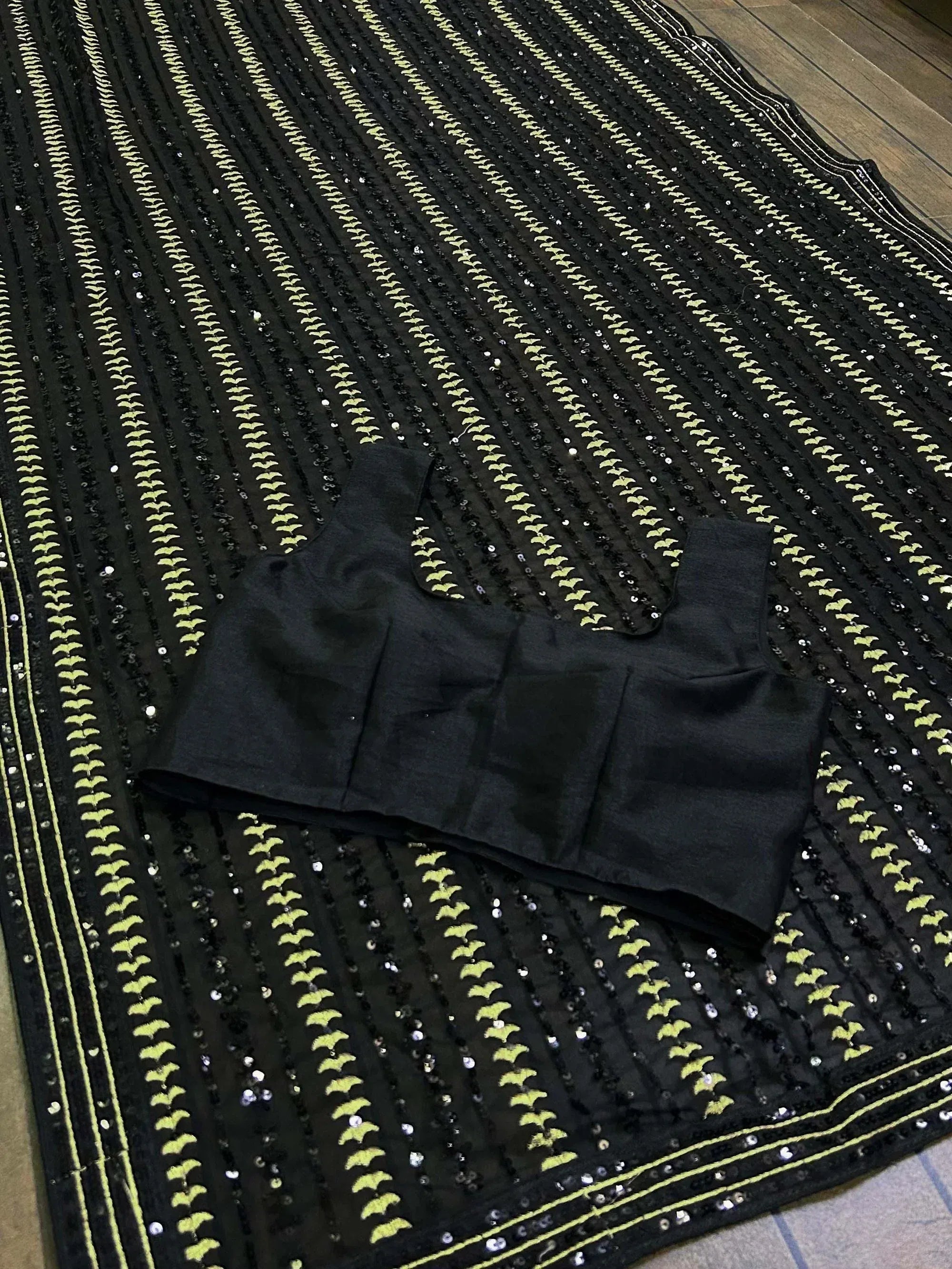 Black ethnic blouse with lime green embroidery and sequins on matching skirt