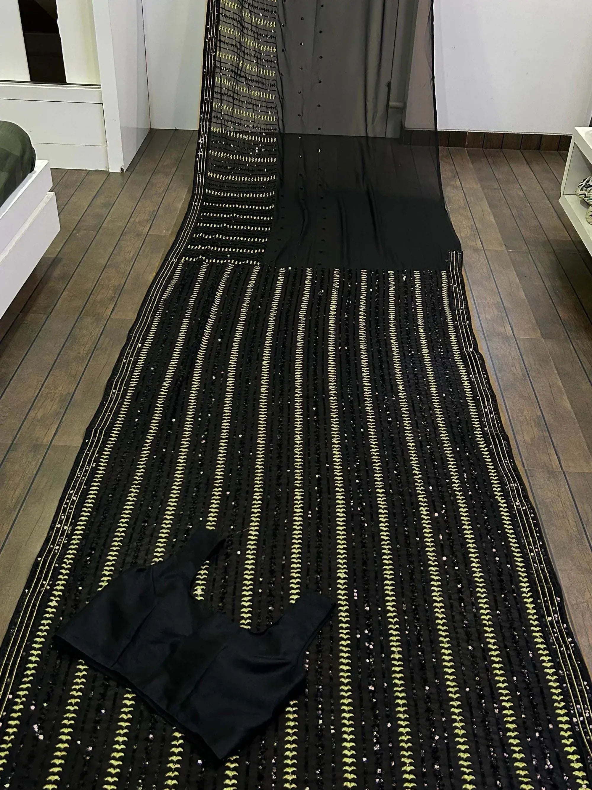 Black ethnic saree with gold embroidery and matching blouse, perfect for Indian festive wear