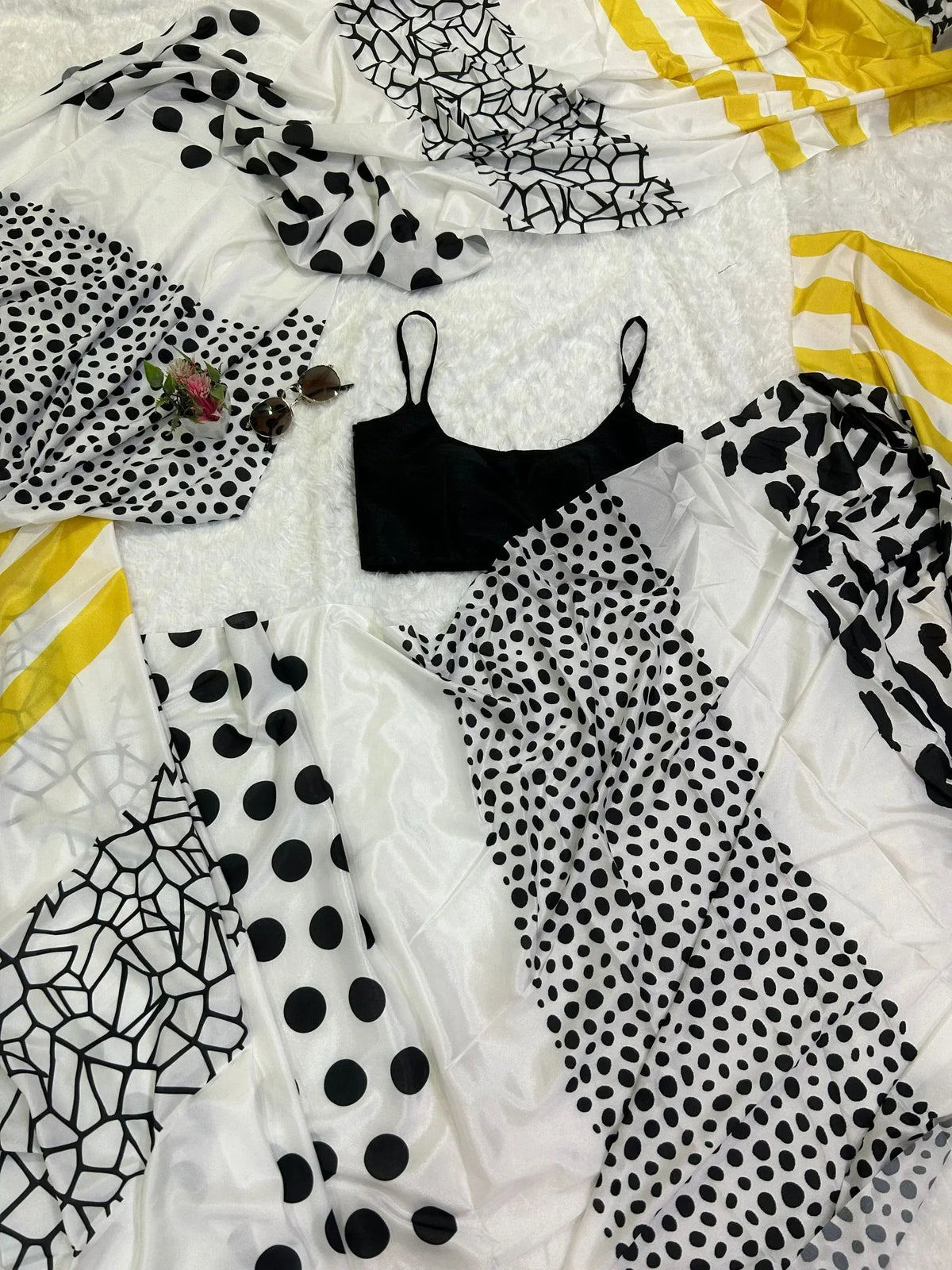 Black polka dot and geometric print ethnic wear with black top on white fur background