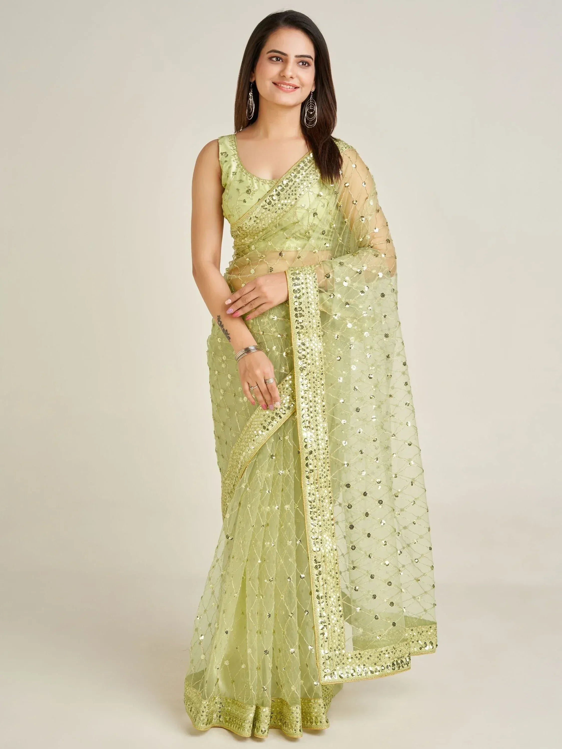 Light green sequin-embellished saree with matching blouse, ideal for Indian ethnic occasions