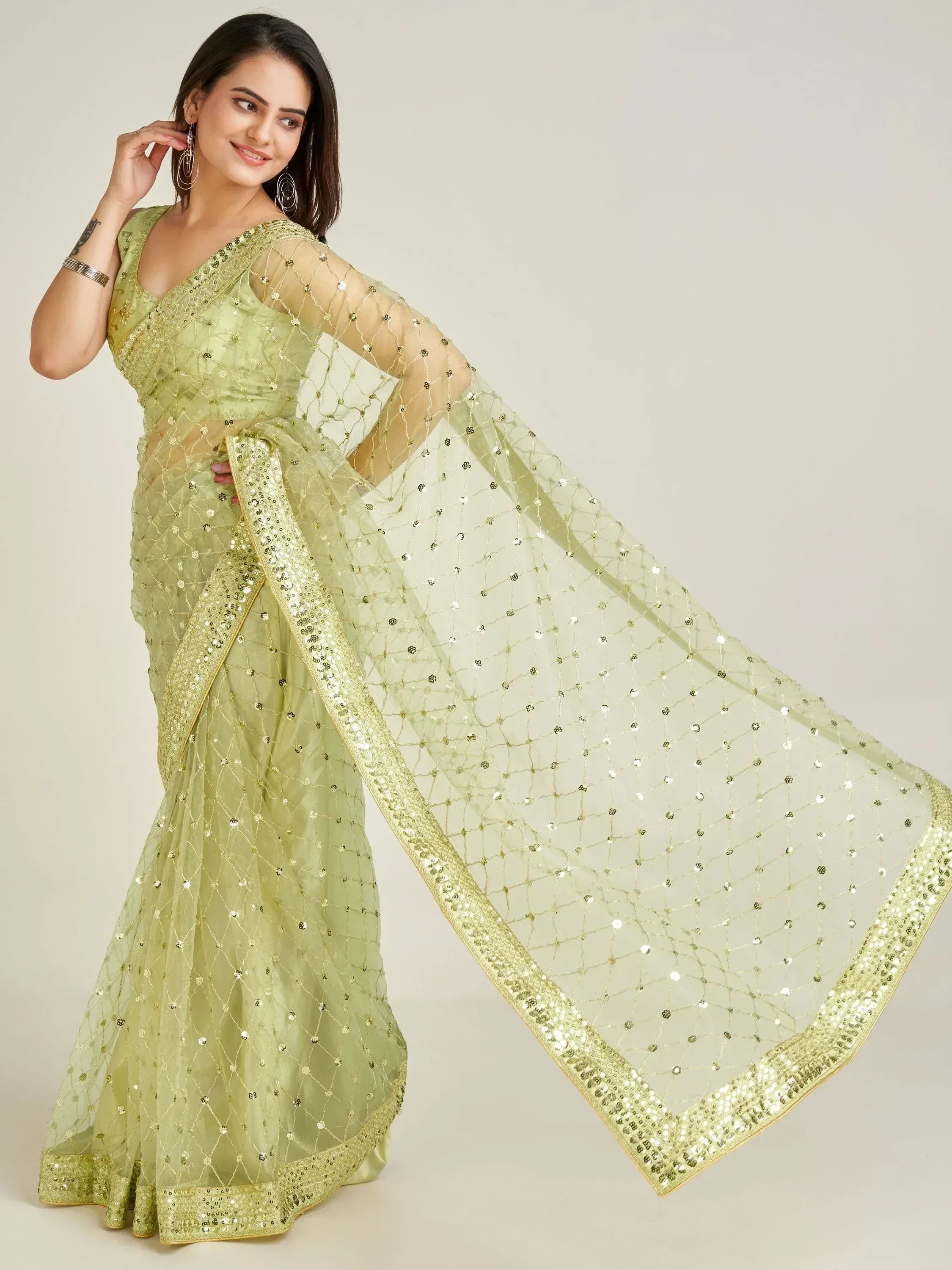 Light green sequin saree with sheer net pallu, perfect for Indian ethnic occasions
