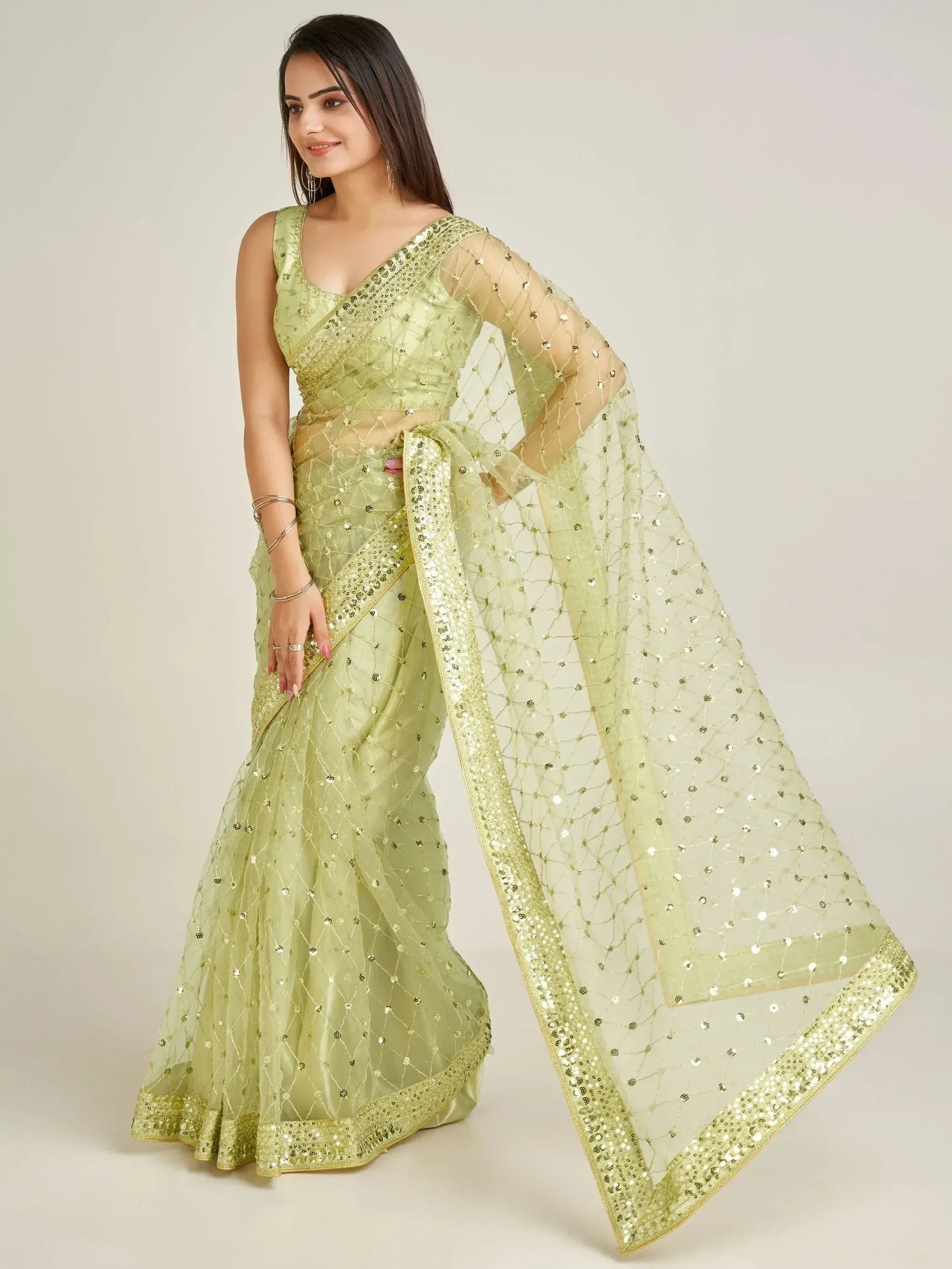 Light green designer saree with sequin embroidery and sheer dupatta, perfect for Indian ethnic wear occasions