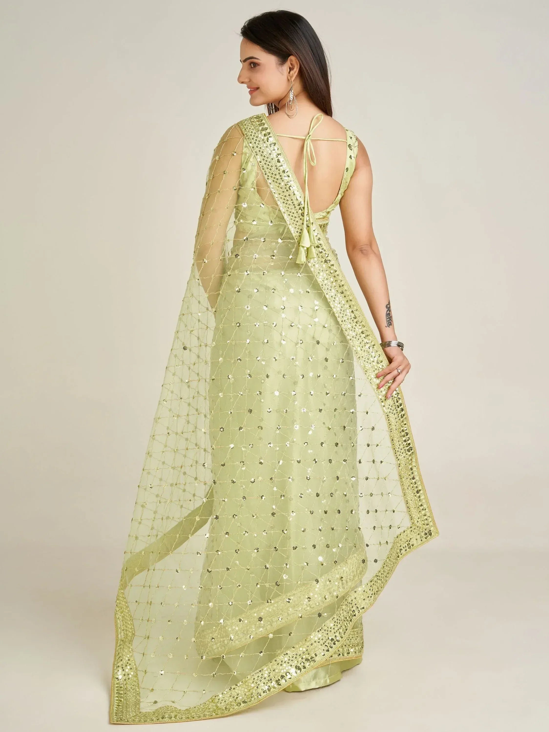 Light green designer ethnic gown with sequin work and sheer dupatta, perfect for Indian occasions
