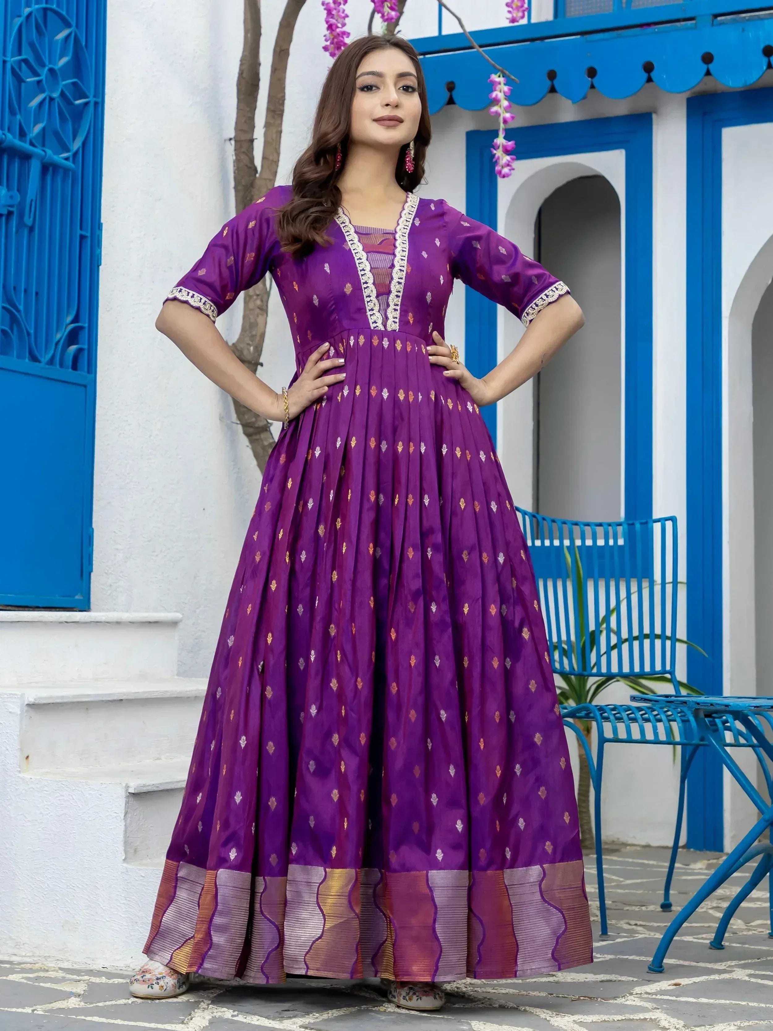 Purple ethnic gown with gold motifs and lace trim, perfect for Indian occasions