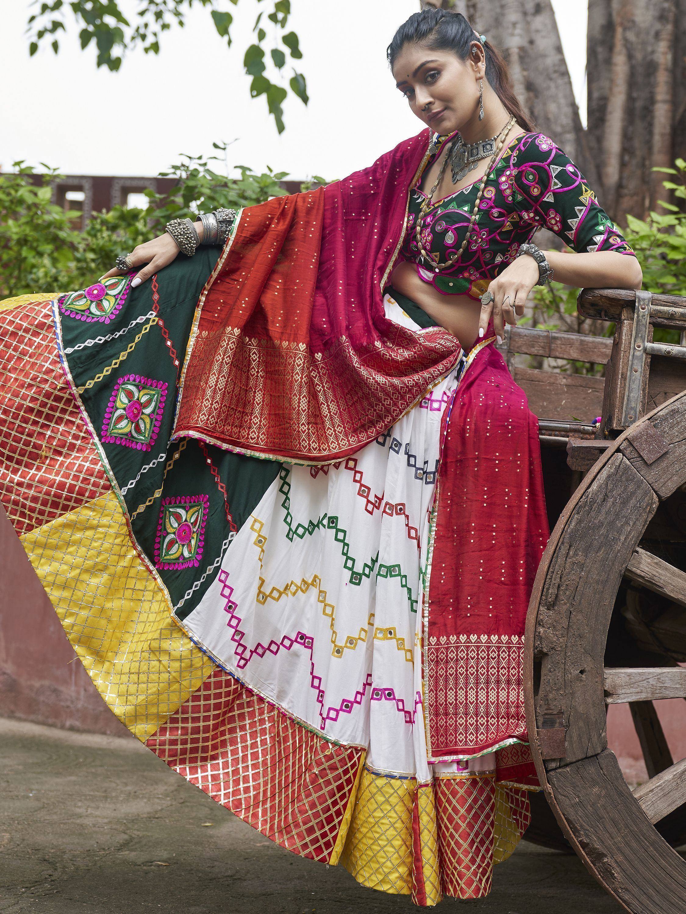 Woman in colorful embroidered lehenga choli with mirror work, perfect for Indian ethnic wear occasions