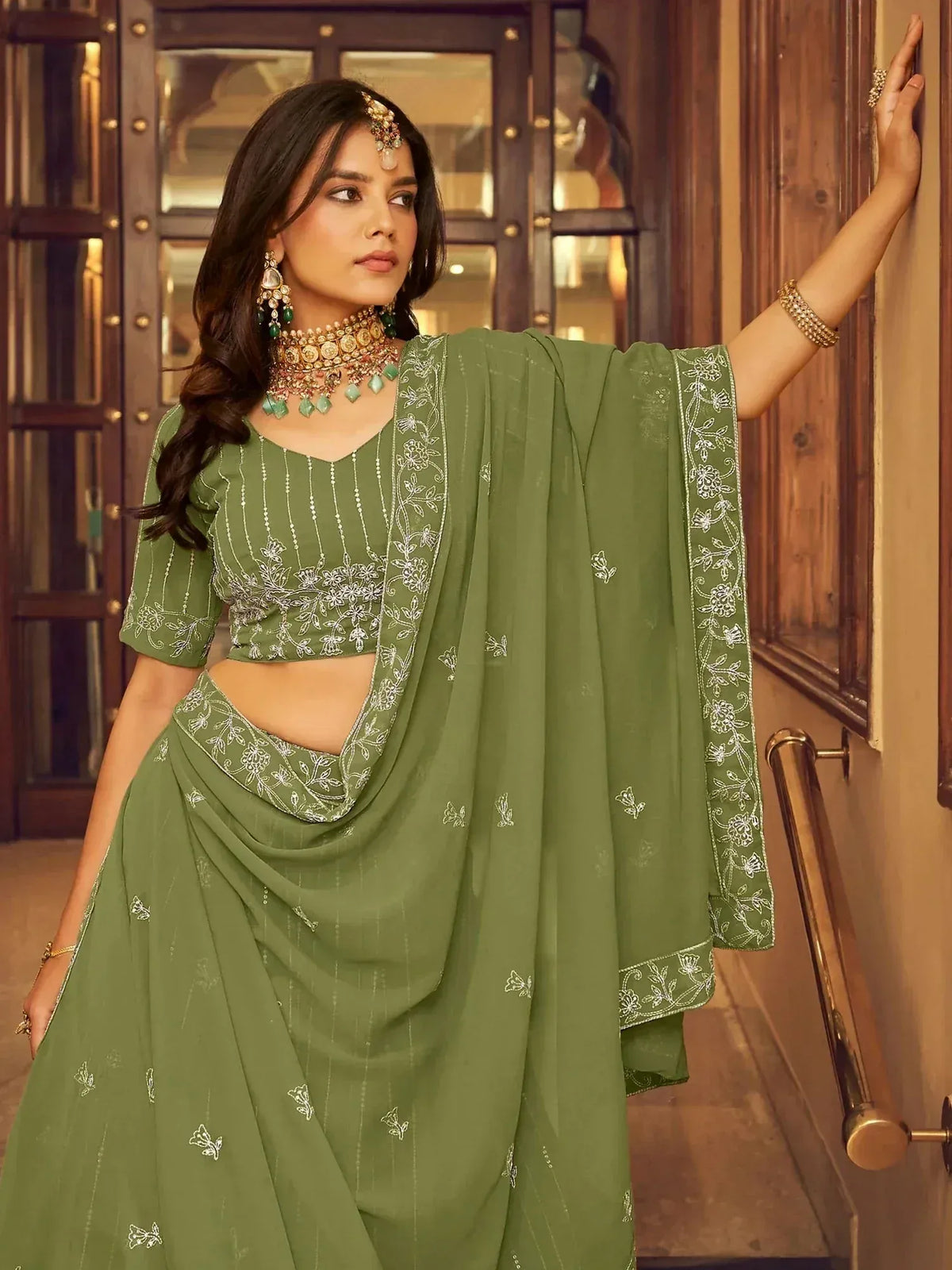Olive green embroidered lehenga choli with floral detailing, perfect for Indian ethnic occasions
