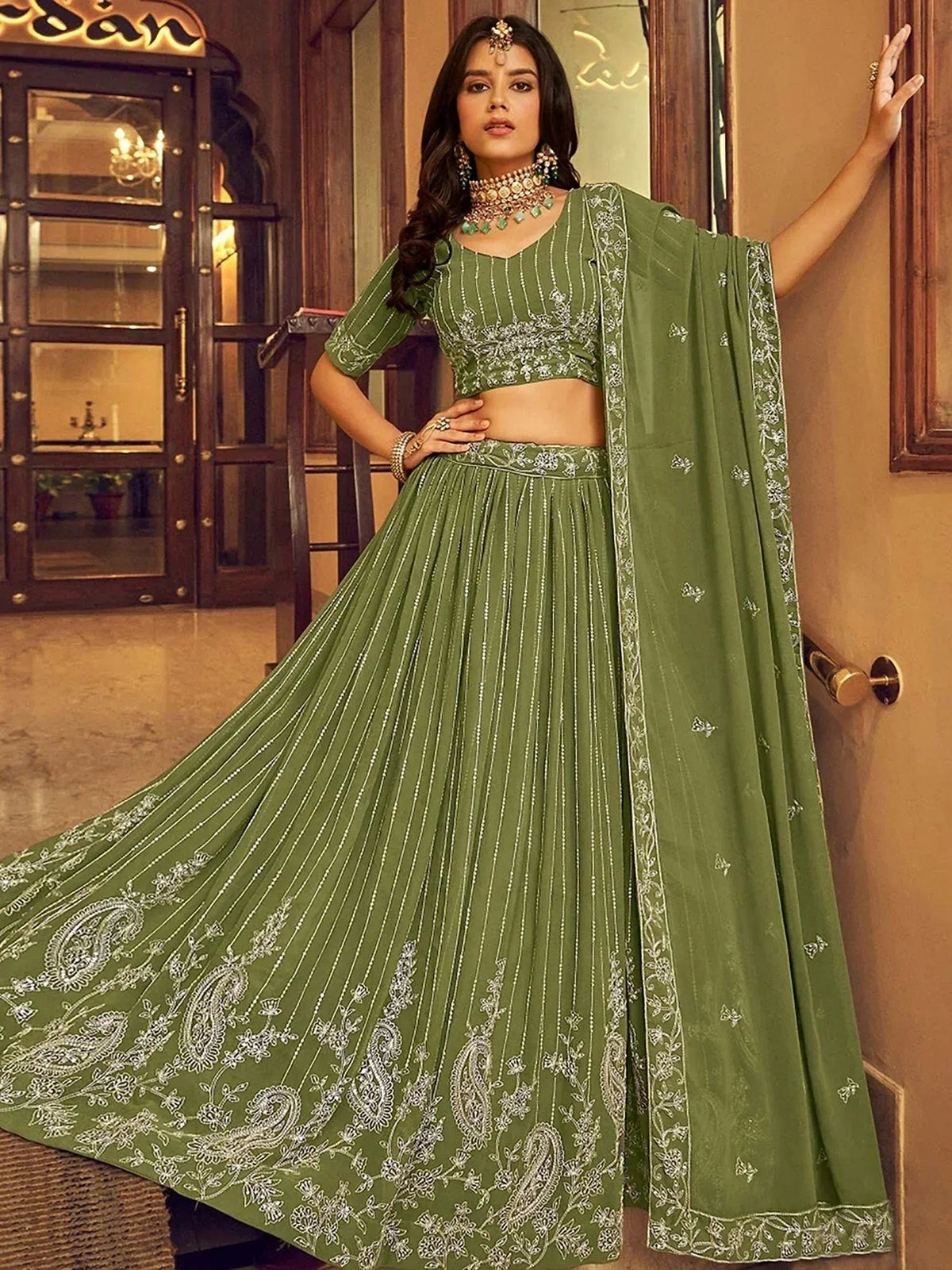 Olive green embroidered lehenga choli with floral and paisley motifs, perfect for Indian ethnic wear occasions.