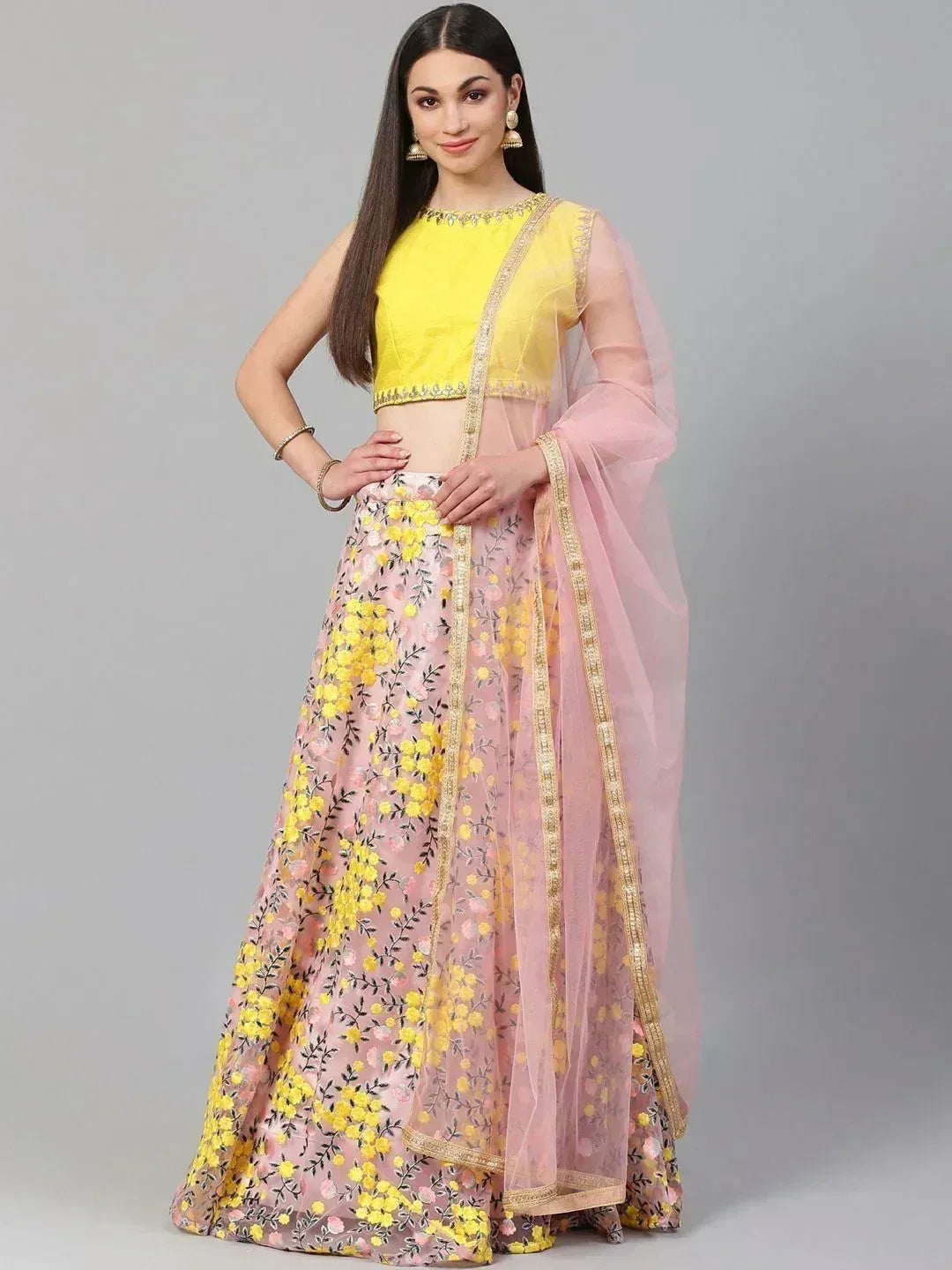 Yellow and pink floral lehenga choli with gold embroidery, perfect for Indian ethnic occasions