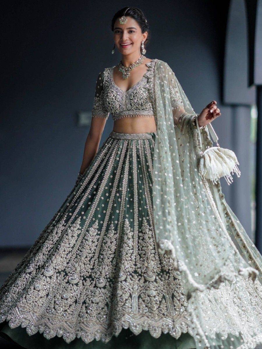 Elegant green designer lehenga choli with heavy embroidery and matching dupatta for Indian weddings