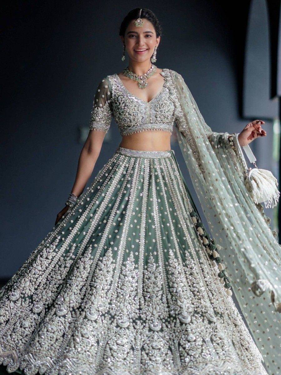 Elegant mint green lehenga choli with heavy silver embroidery, perfect for Indian weddings and festive occasions.