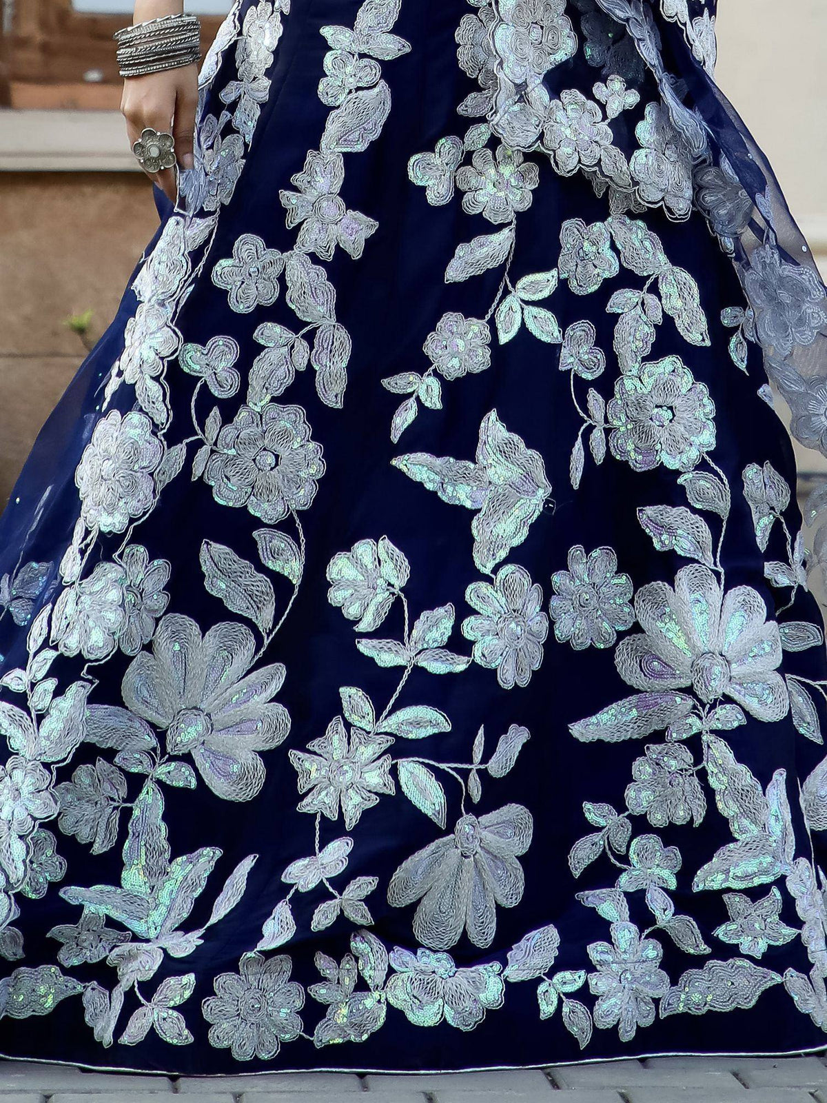 Navy blue lehenga with silver floral embroidery and sequins, perfect for Indian ethnic wear events.