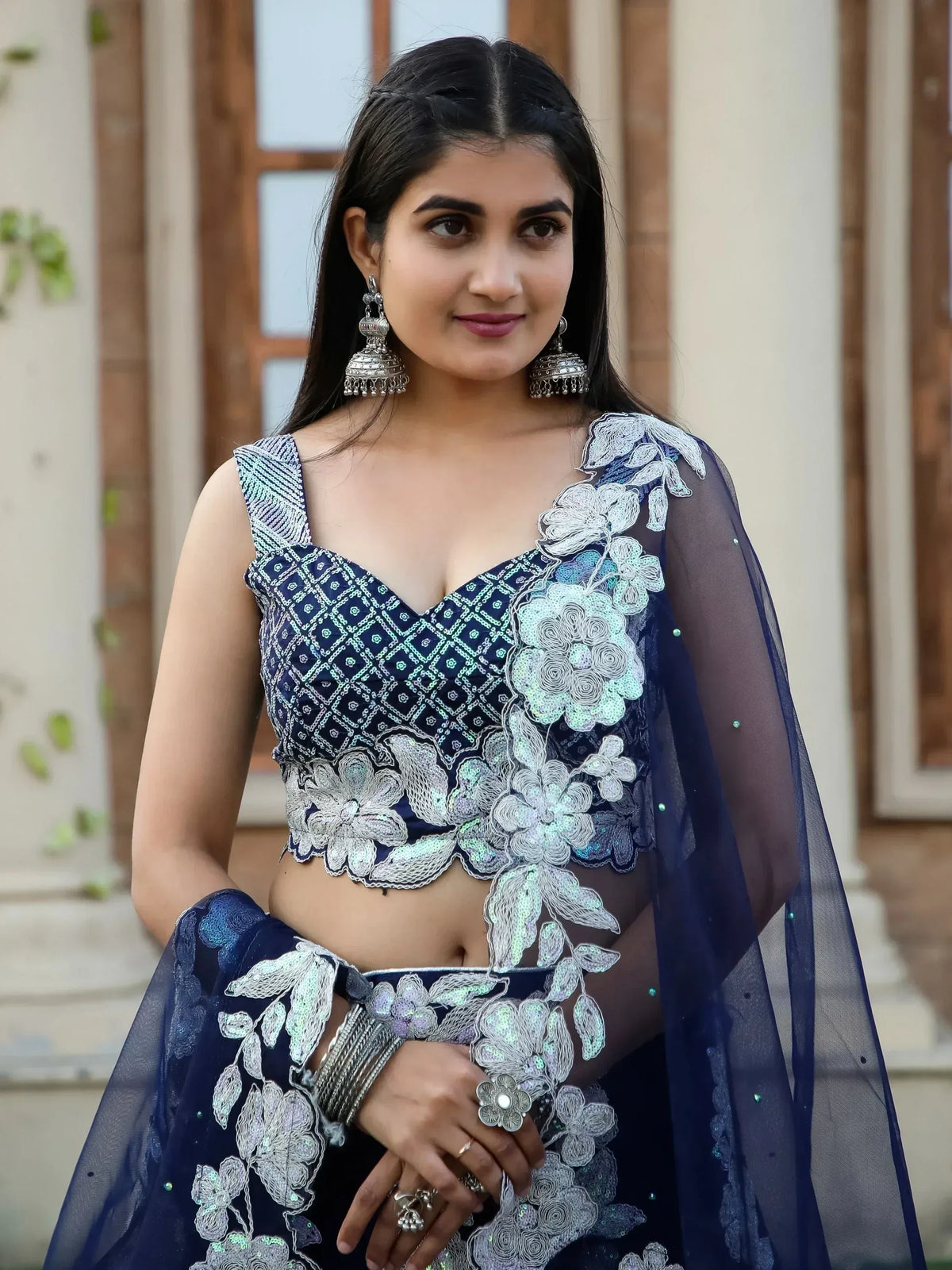 Navy blue designer lehenga choli with floral embroidery and sheer dupatta, perfect for Indian ethnic occasions