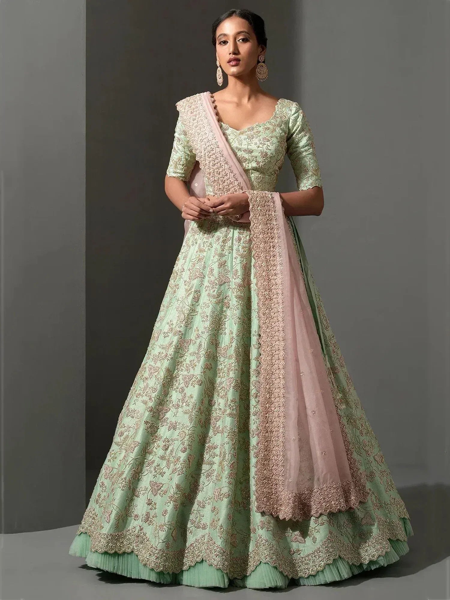 Mint green embroidered lehenga choli with pink dupatta, perfect for weddings and festive occasions.