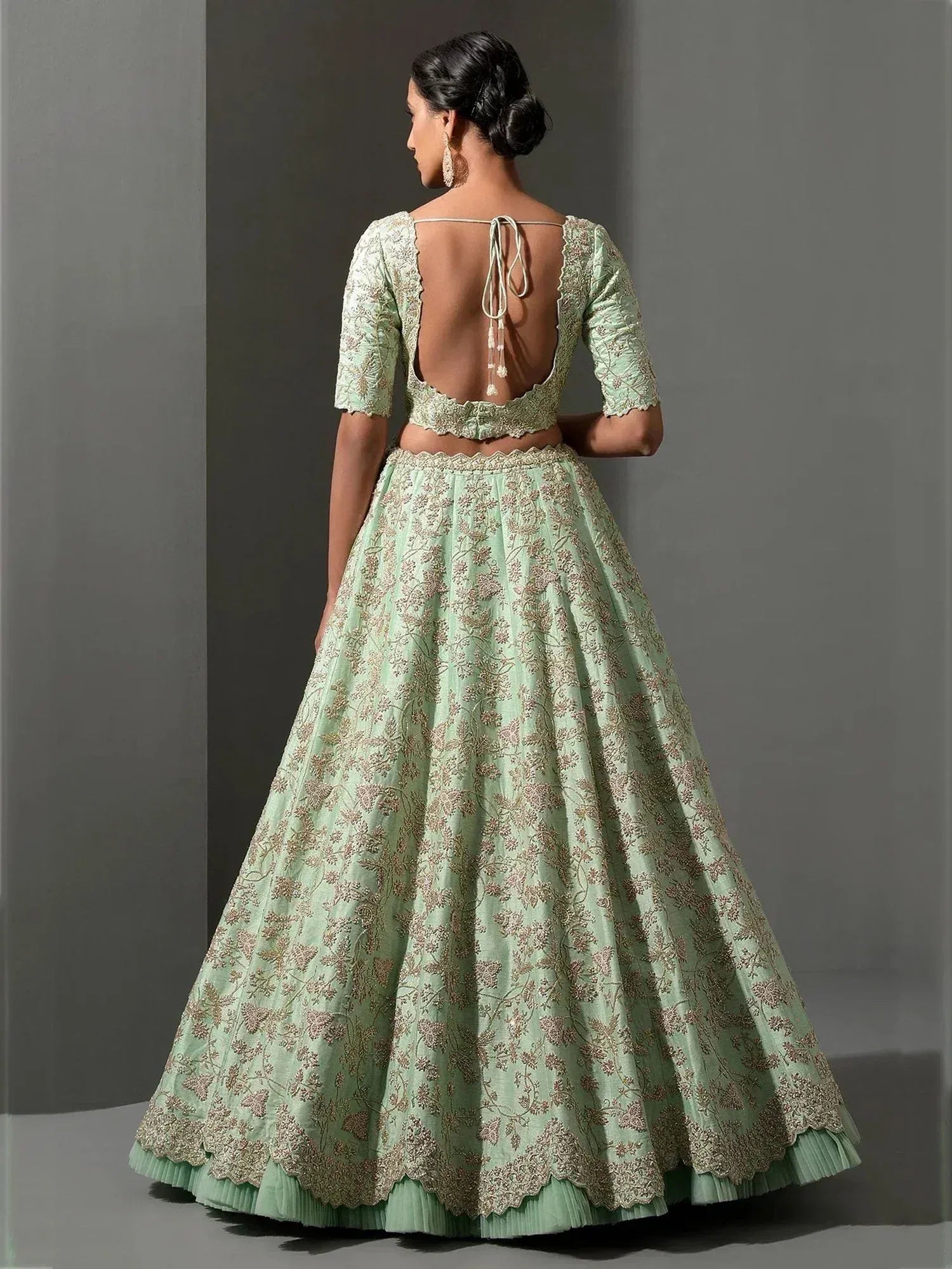 Mint green embroidered lehenga choli with back tie detail, floral motifs, and scalloped hem for Indian ethnic wear