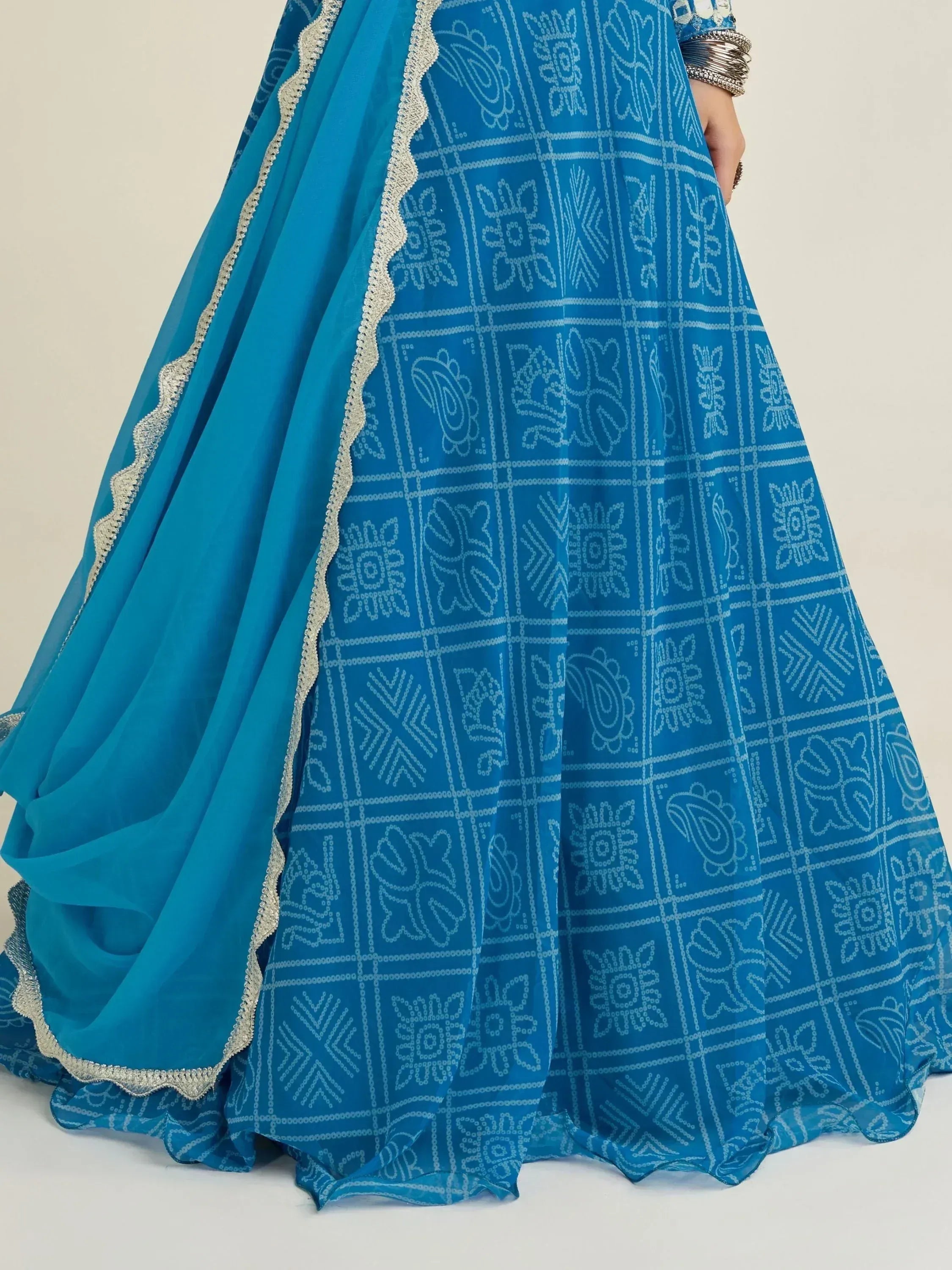 Blue ethnic lehenga with white block print patterns and silver lace trim, perfect for Indian weddings or festivals.