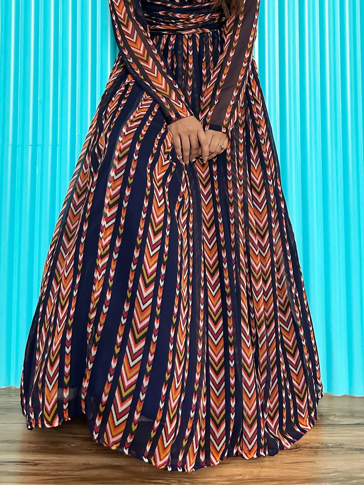 Ethnic gown with vibrant chevron print, long sleeves, and pleated skirt for women