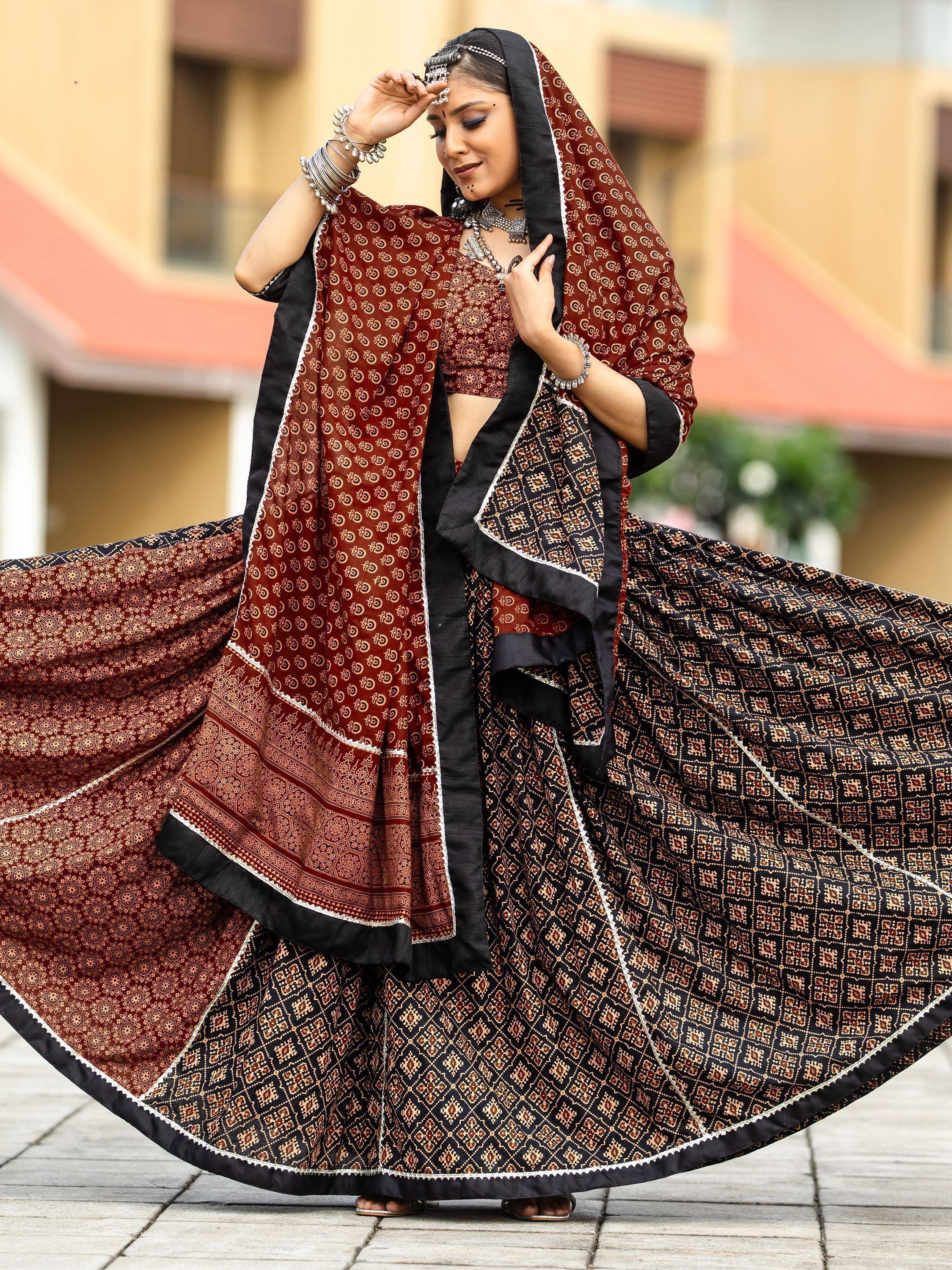 Woman in maroon and black printed lehenga choli with dupatta, traditional Indian ethnic wear