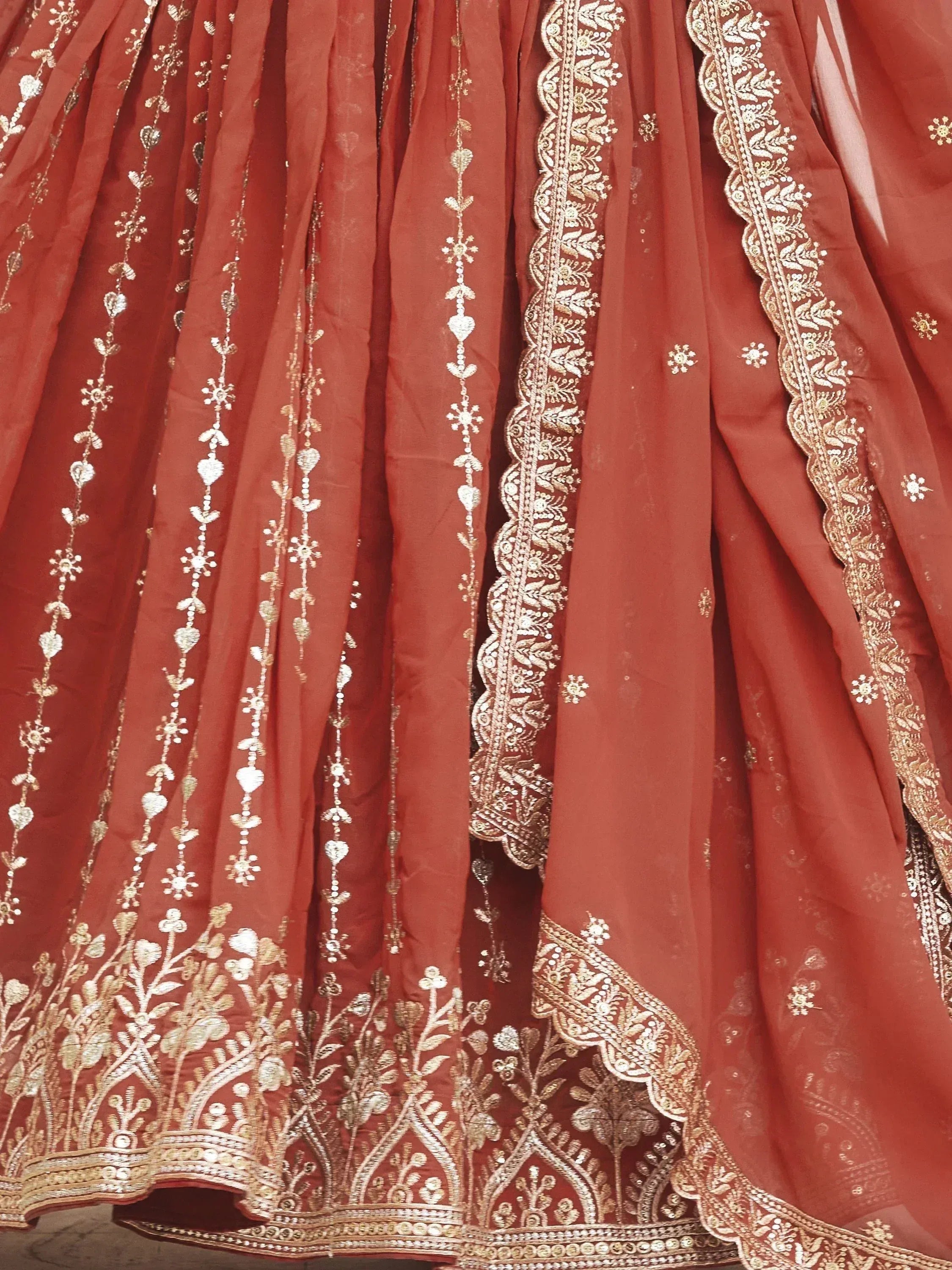 Red designer lehenga with gold floral embroidery and scalloped border, ethnic Indian wear