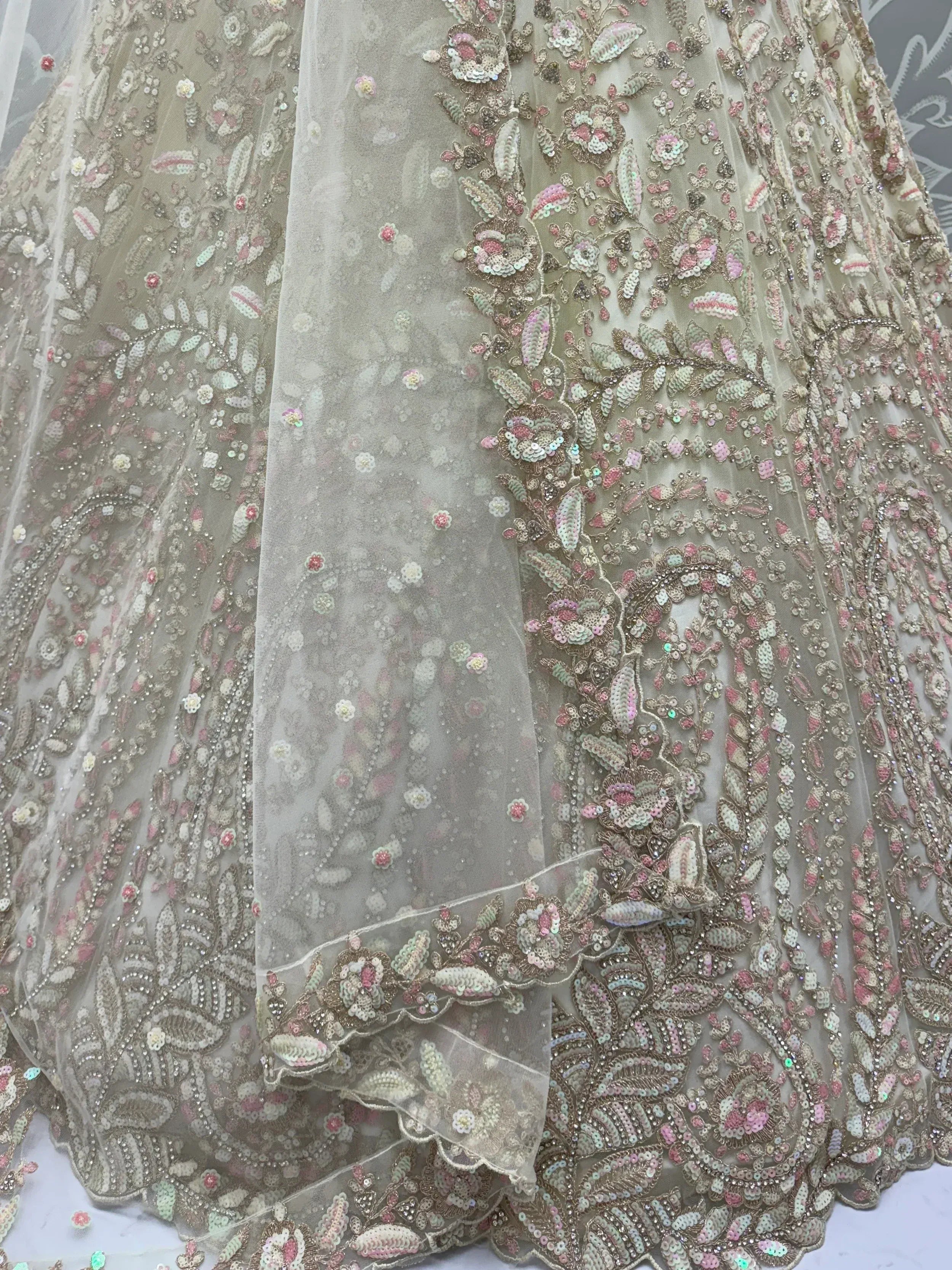 Elegant beige lehenga with intricate floral sequin embroidery and sheer overlay for Indian ethnic wear