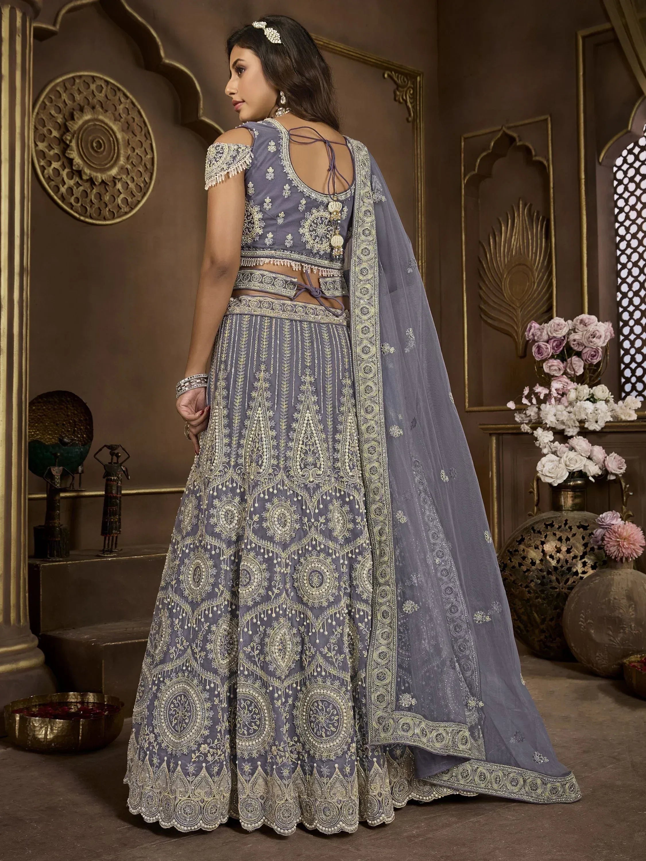 Grey embroidered lehenga choli with gold detailing, perfect for Indian weddings and festive occasions.