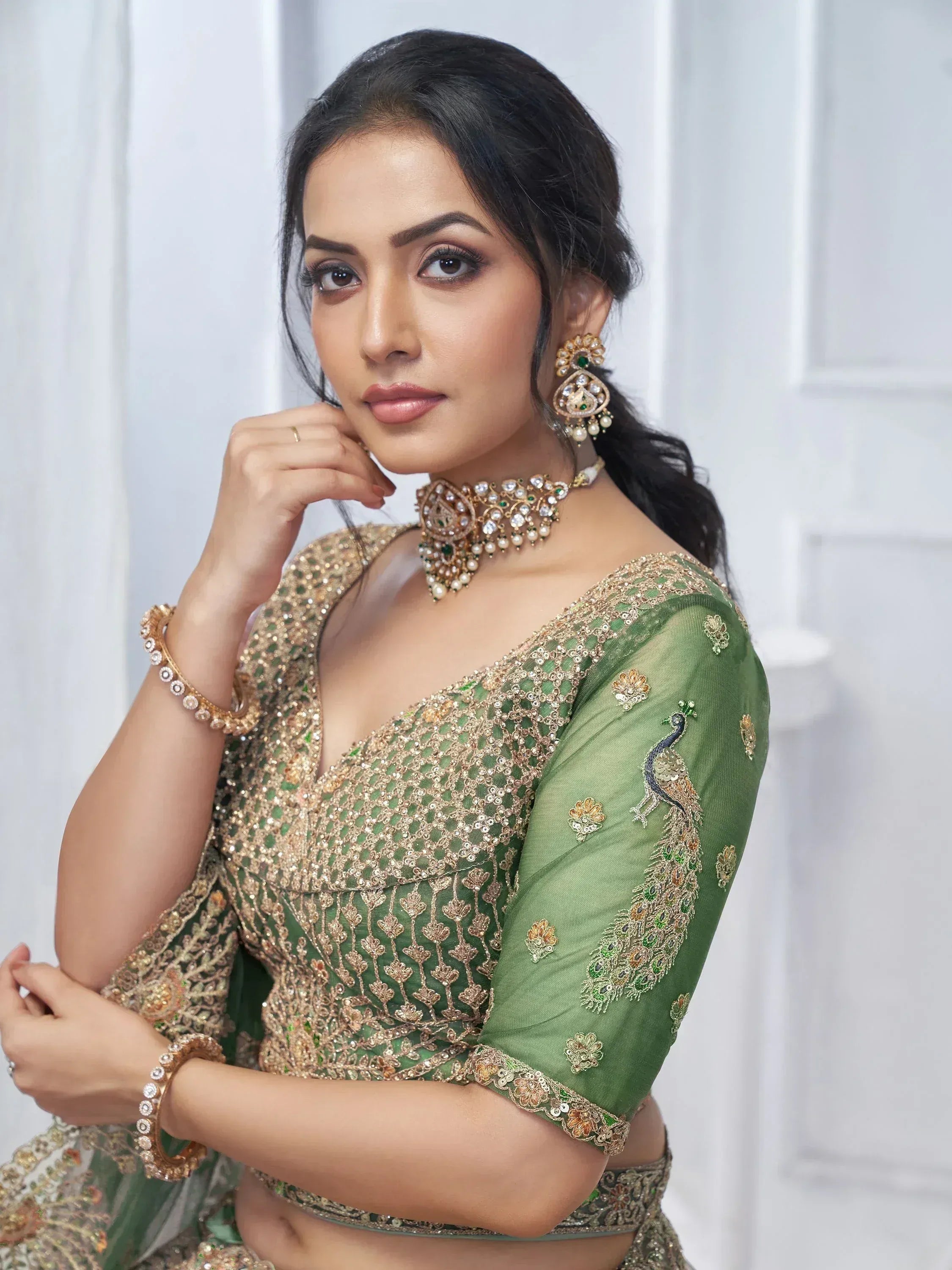 Green embroidered lehenga choli with peacock design, perfect for Indian ethnic wear and festive occasions.