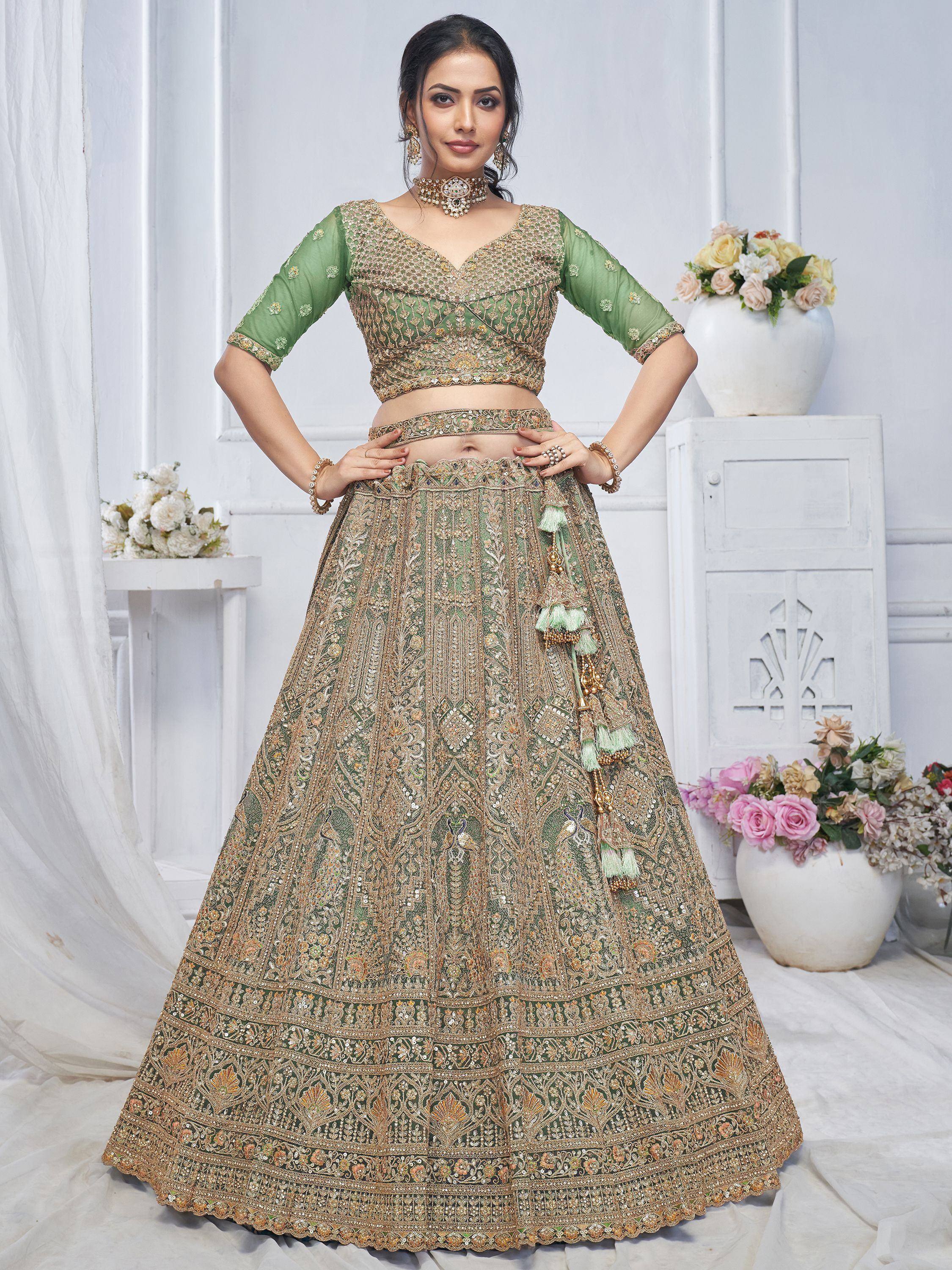 Green and gold embroidered lehenga choli with tassels, perfect for Indian weddings and festive occasions