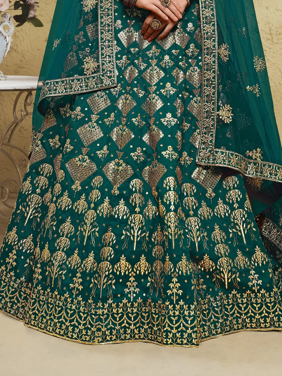 Emerald green lehenga with gold embroidery and mirror work, perfect for Indian ethnic wear