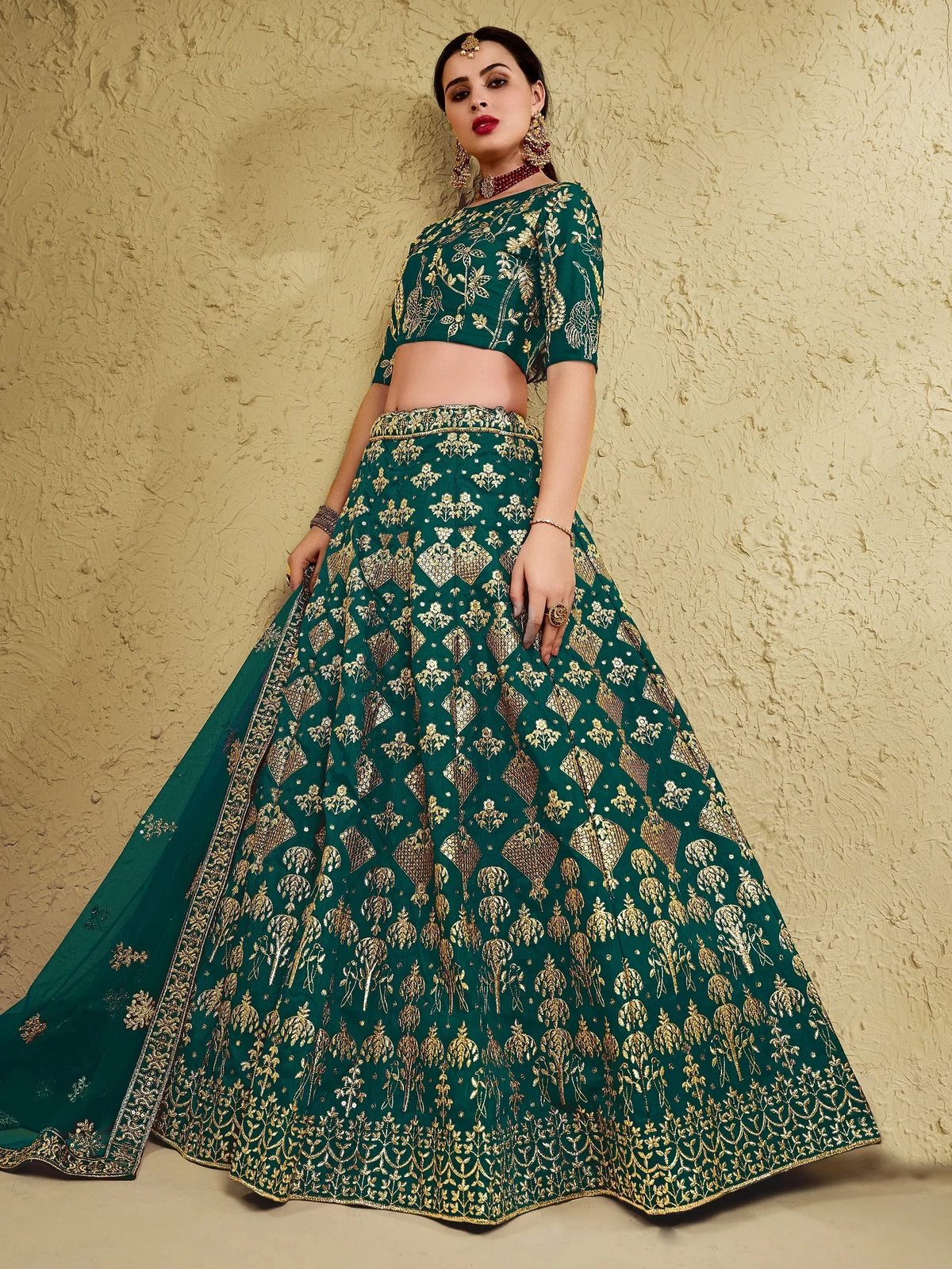 Emerald green lehenga choli with gold embroidery, perfect for Indian weddings and festive occasions.