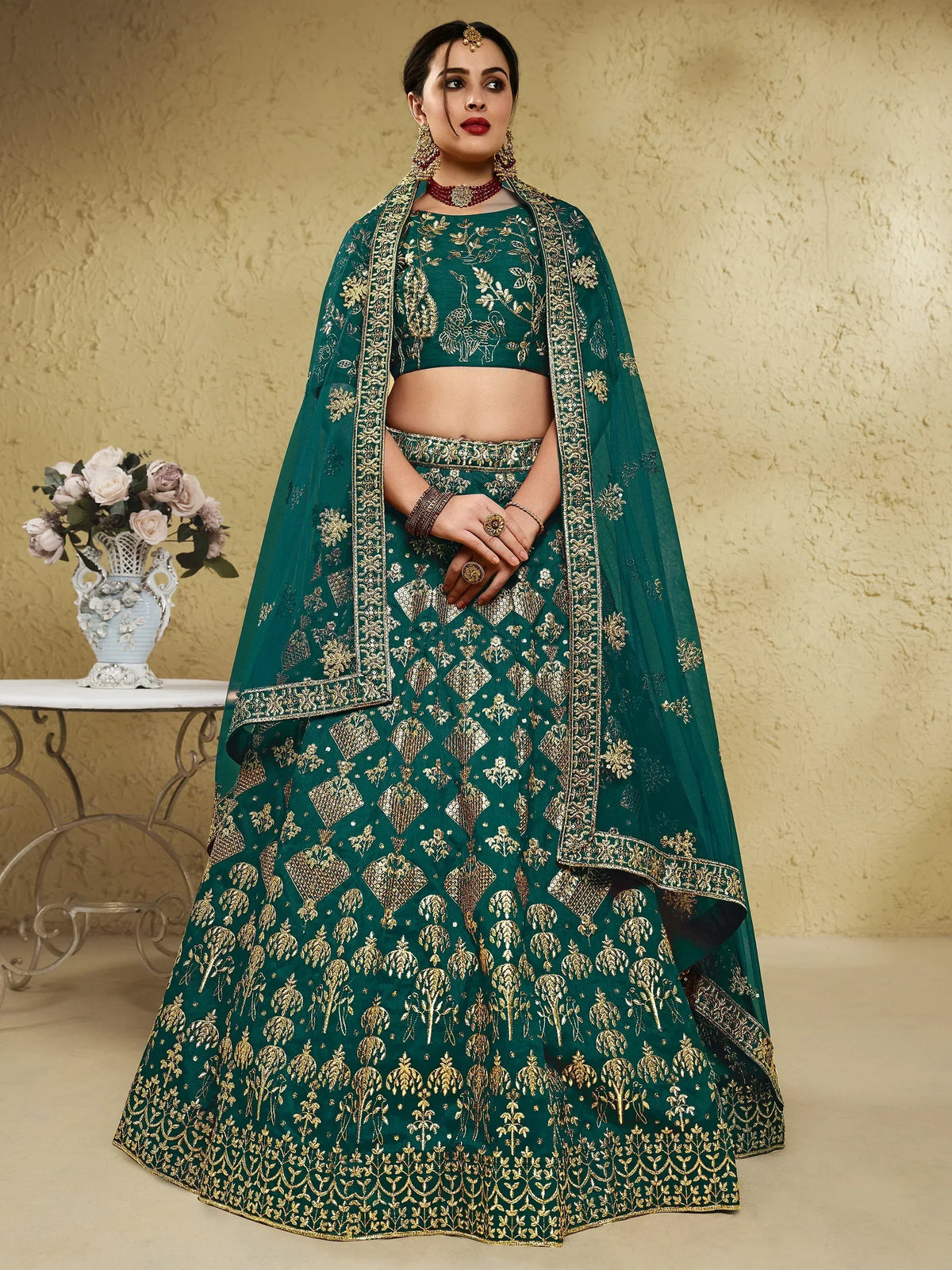 Emerald green designer lehenga choli with gold embroidery, perfect for Indian weddings and festive occasions.