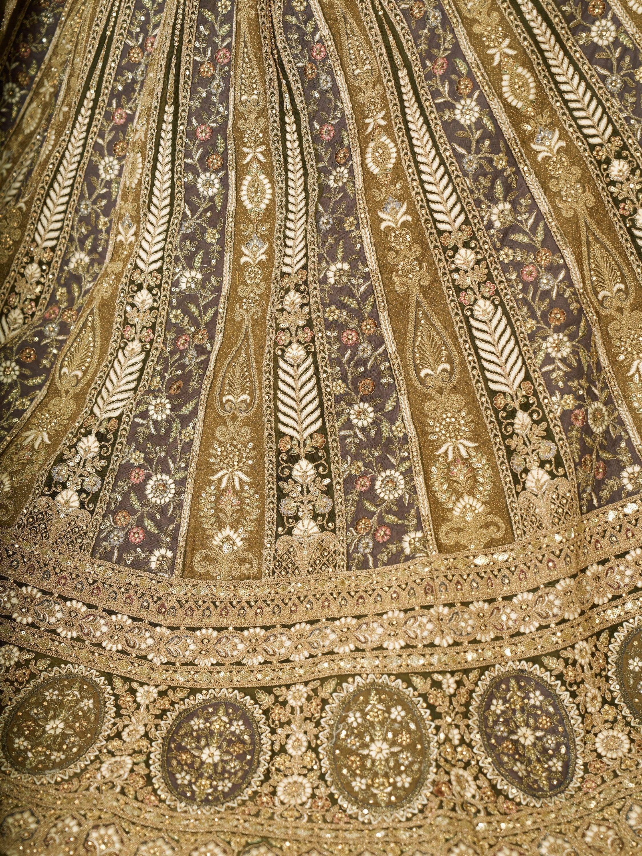 Luxury Indian lehenga with intricate gold embroidery, floral motifs, and sequin detailing for weddings and festivals.