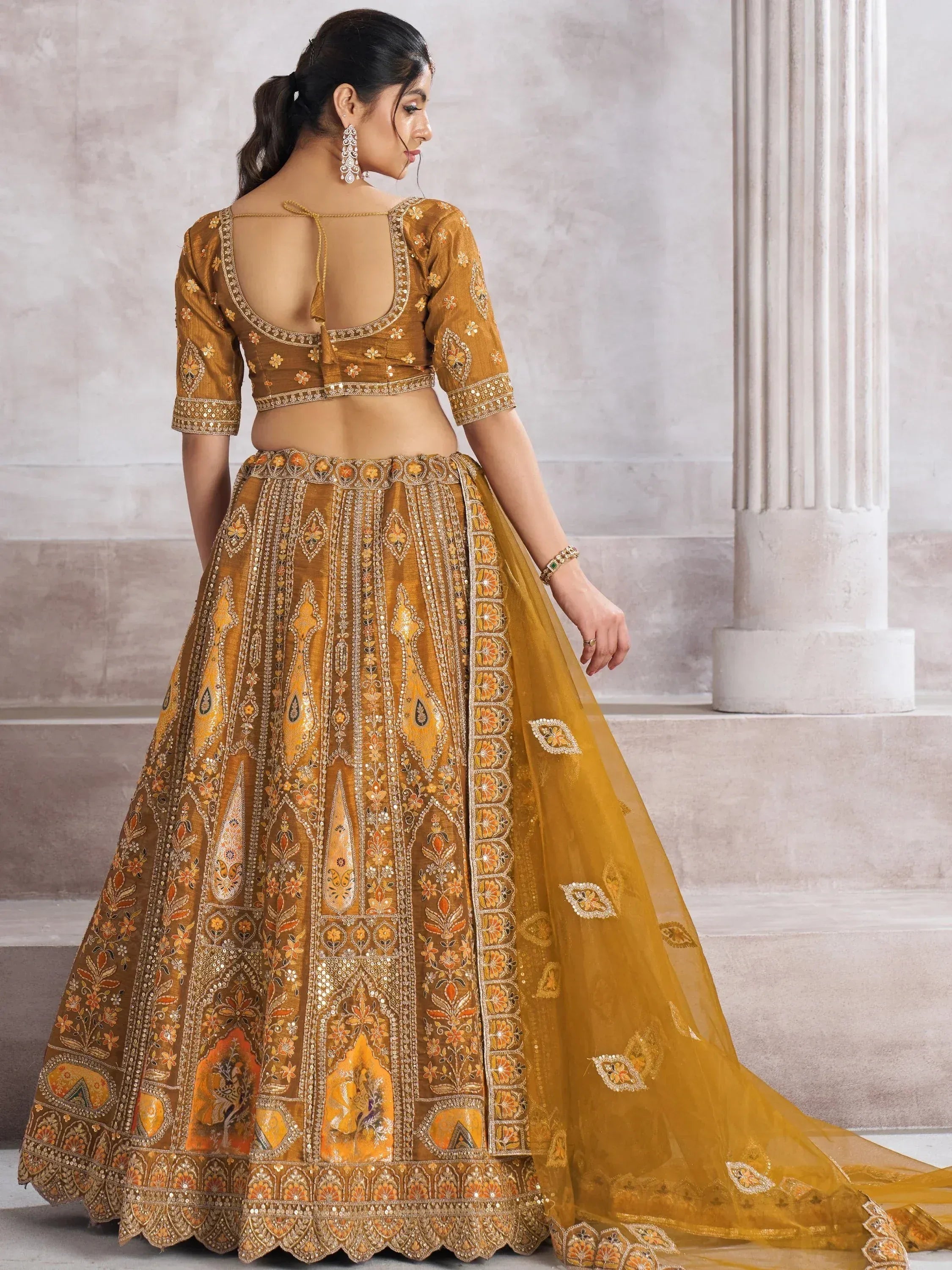 Golden embroidered lehenga choli with floral motifs, back view, ethnic Indian wear