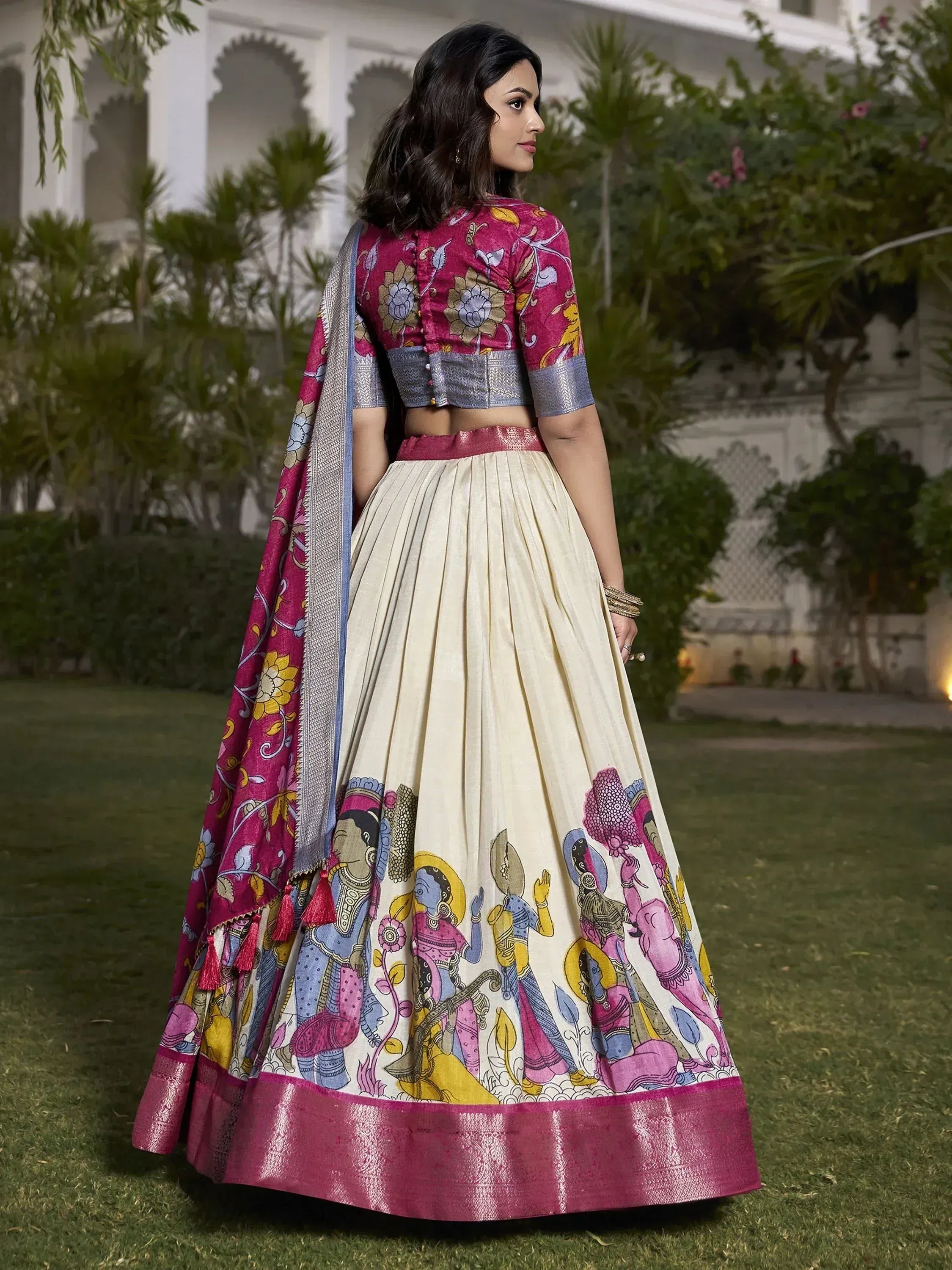 Woman in vibrant Indian lehenga choli with floral and folk art print, perfect for ethnic occasions