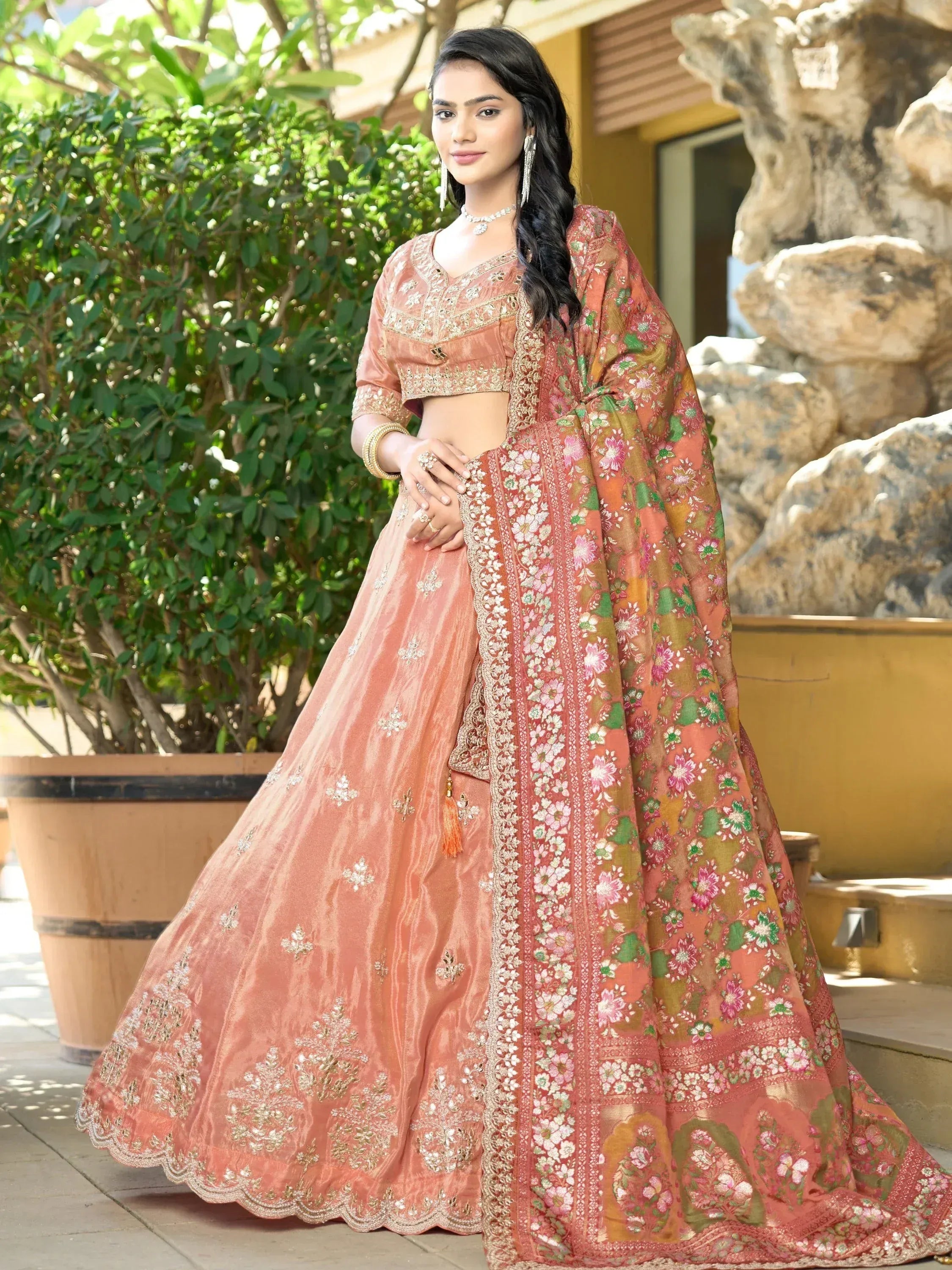 Elegant peach lehenga choli with floral dupatta, perfect for Indian ethnic wear occasions