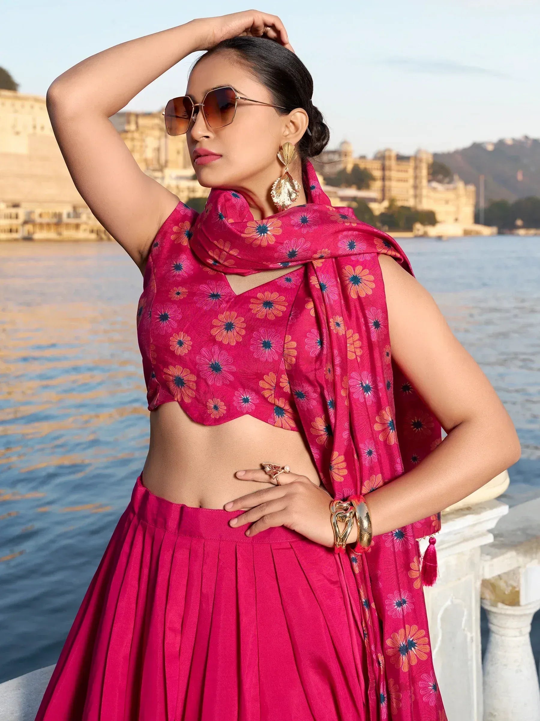 Pink floral lehenga choli with matching dupatta, styled with gold jewelry by lakeside palace