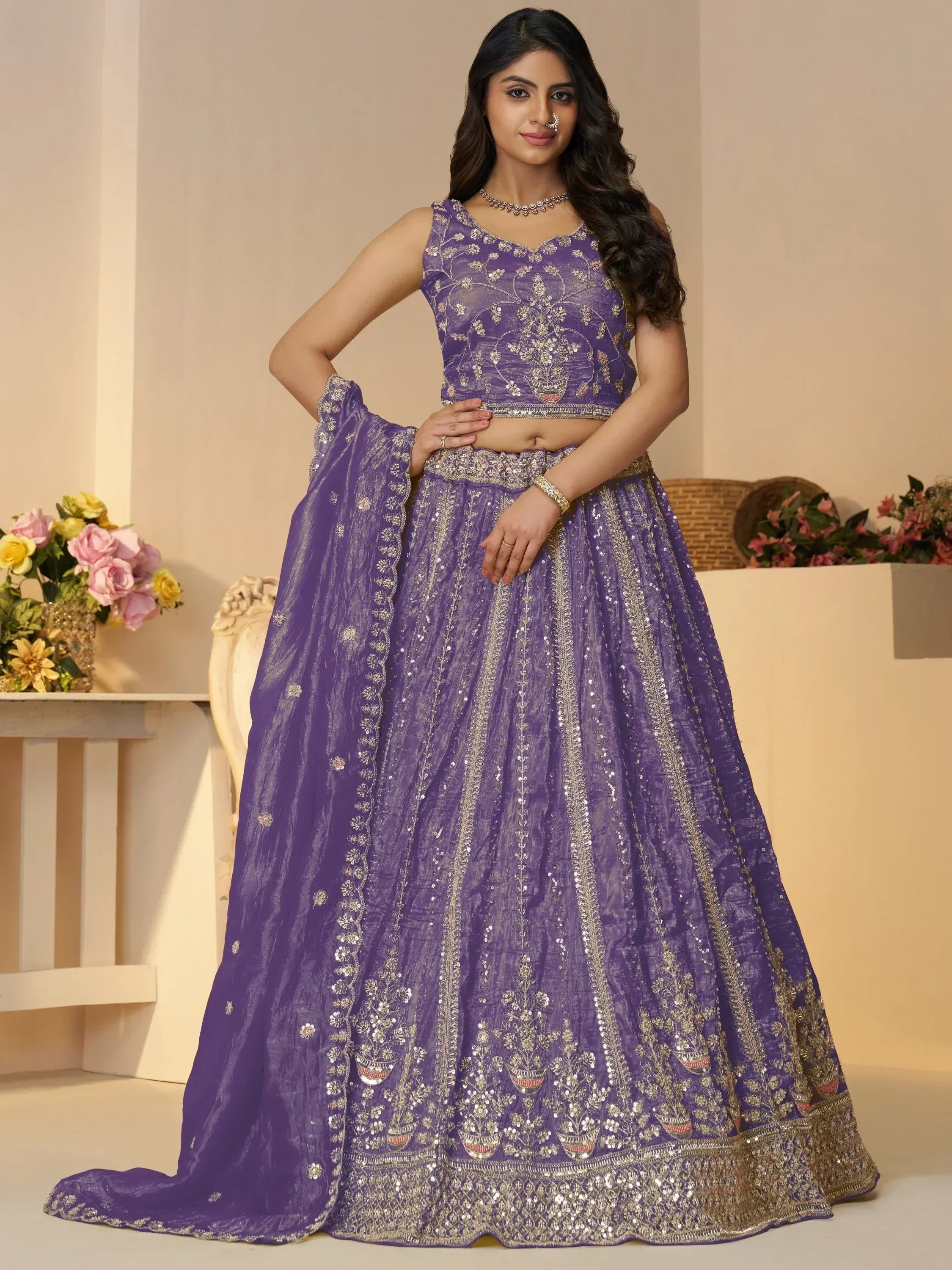 Purple embroidered lehenga choli with gold detailing, perfect for Indian weddings and festive occasions