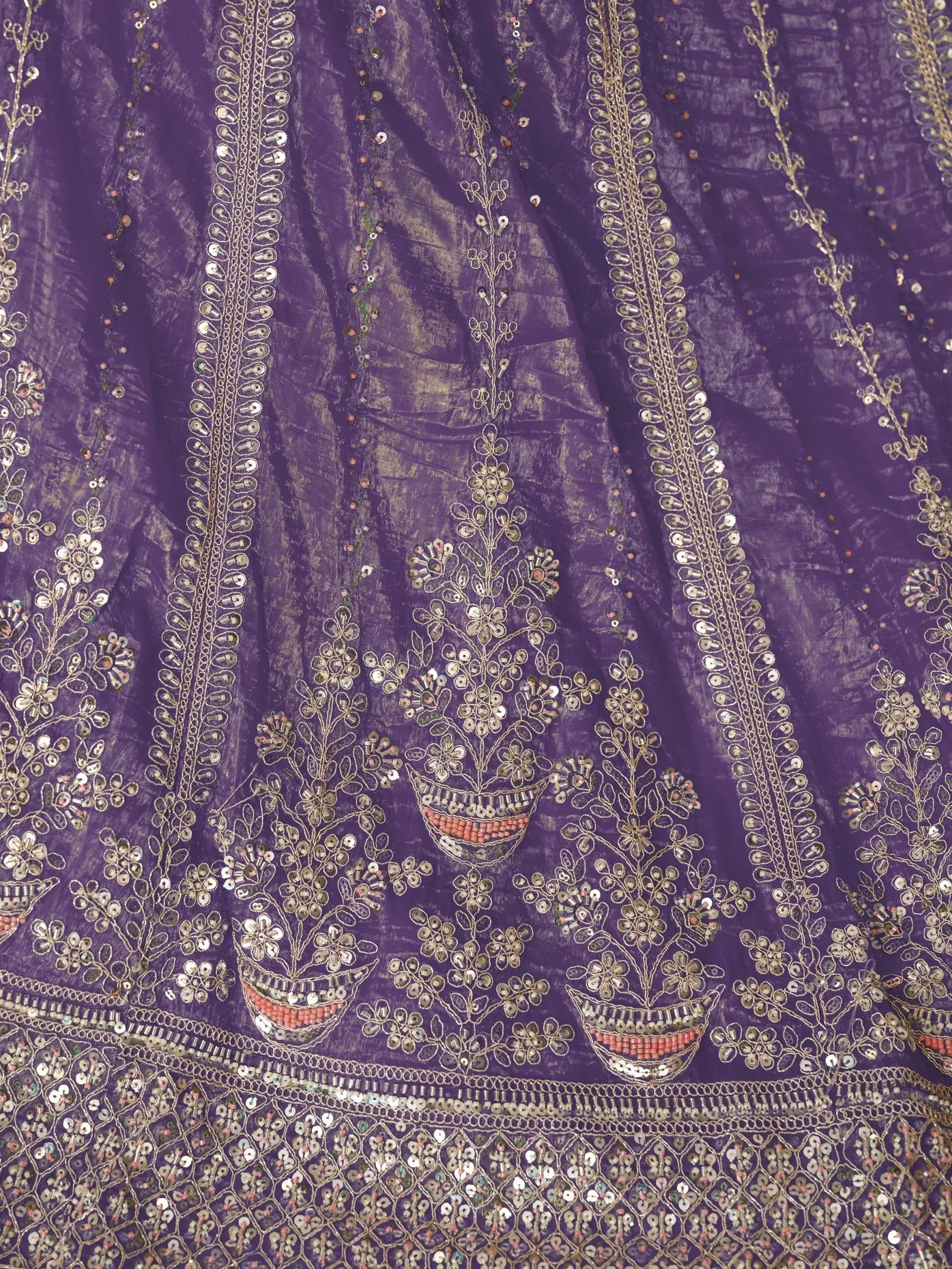 Purple ethnic gown with gold embroidery and mirror work, perfect for Indian festive wear
