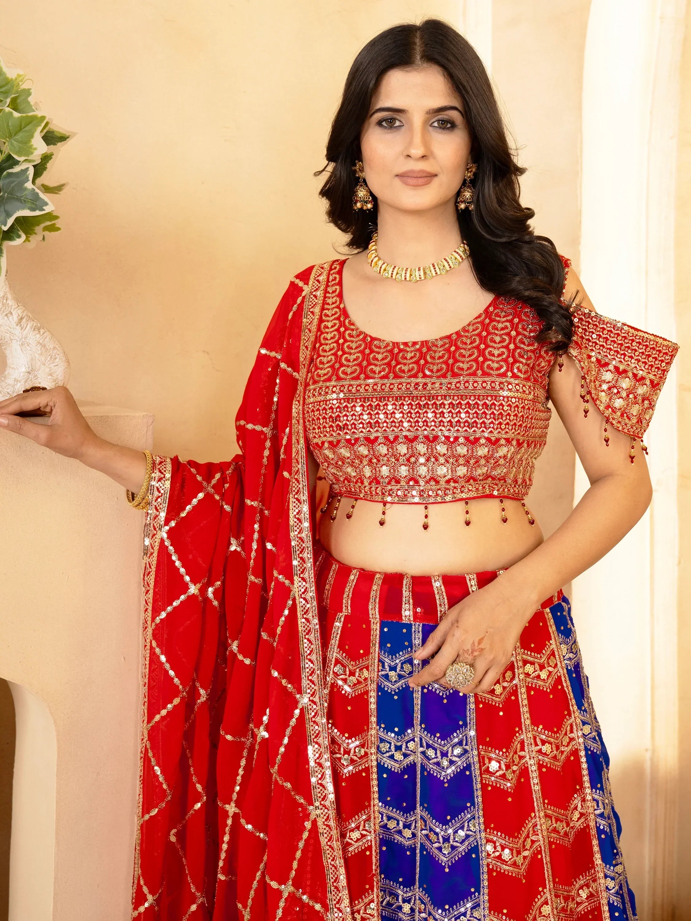 Red and blue embroidered lehenga choli with gold detailing, perfect for Indian ethnic wear occasions