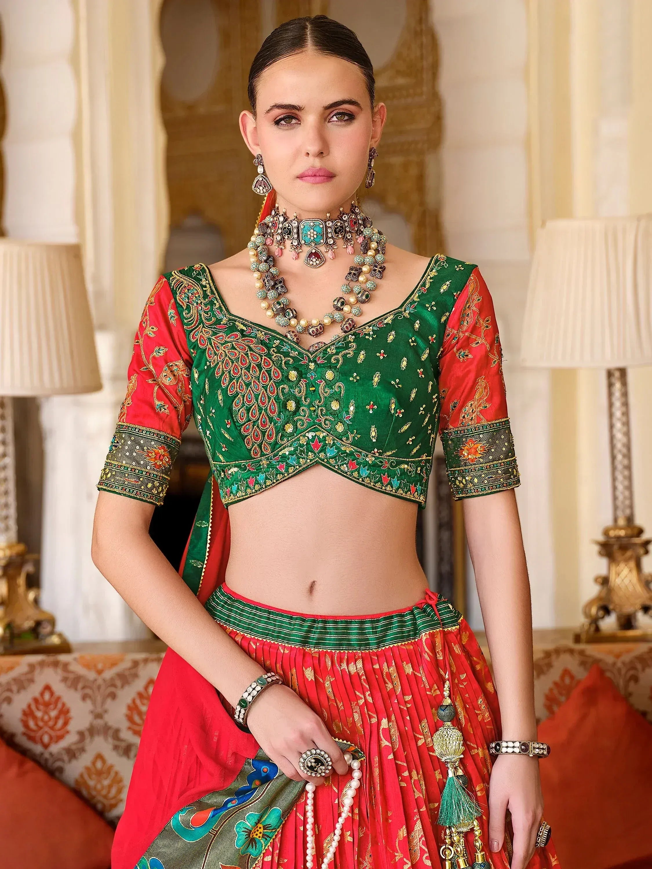 Green and red embroidered lehenga choli with peacock motifs, traditional Indian ethnic wear for women