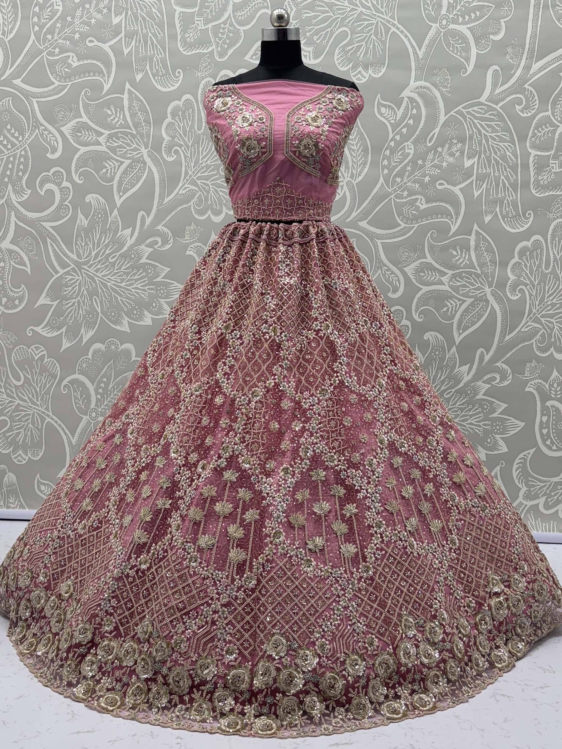 Pink designer lehenga with gold embroidery and floral patterns, perfect for Indian ethnic wear occasions