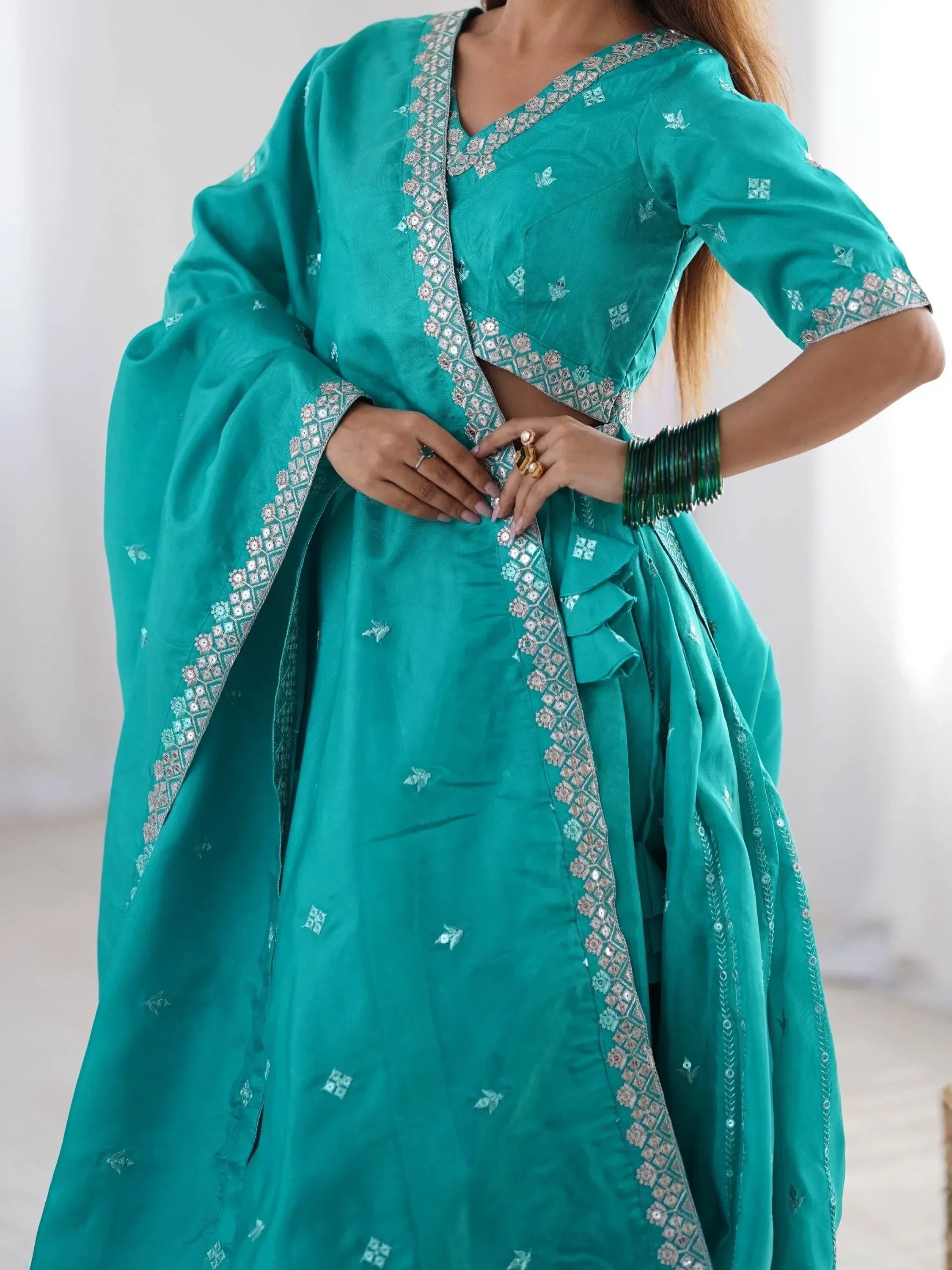 Teal designer lehenga choli with silver embroidery and mirror work, perfect for Indian ethnic wear
