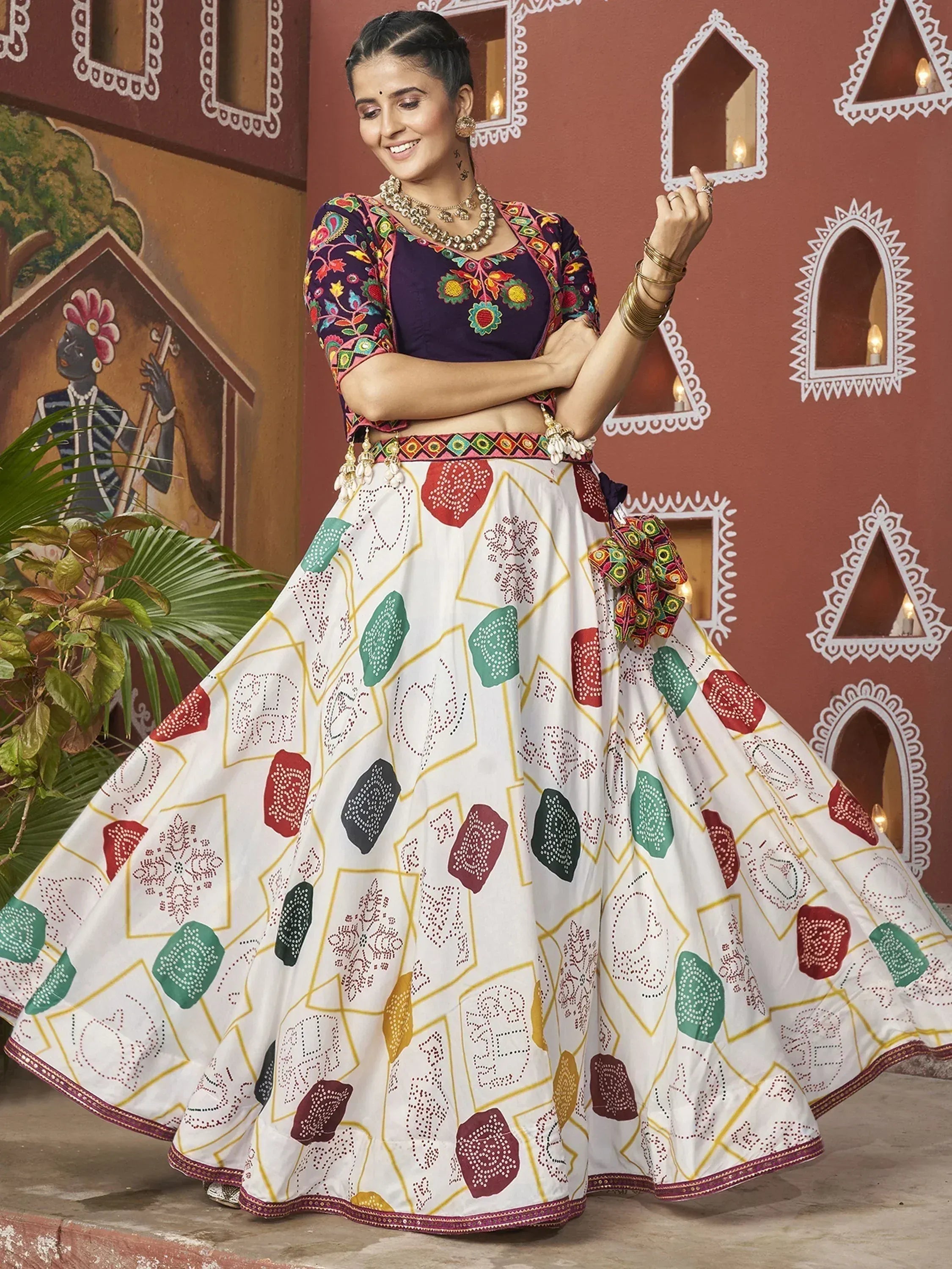 Woman in colorful embroidered lehenga choli with geometric print, traditional Indian ethnic wear