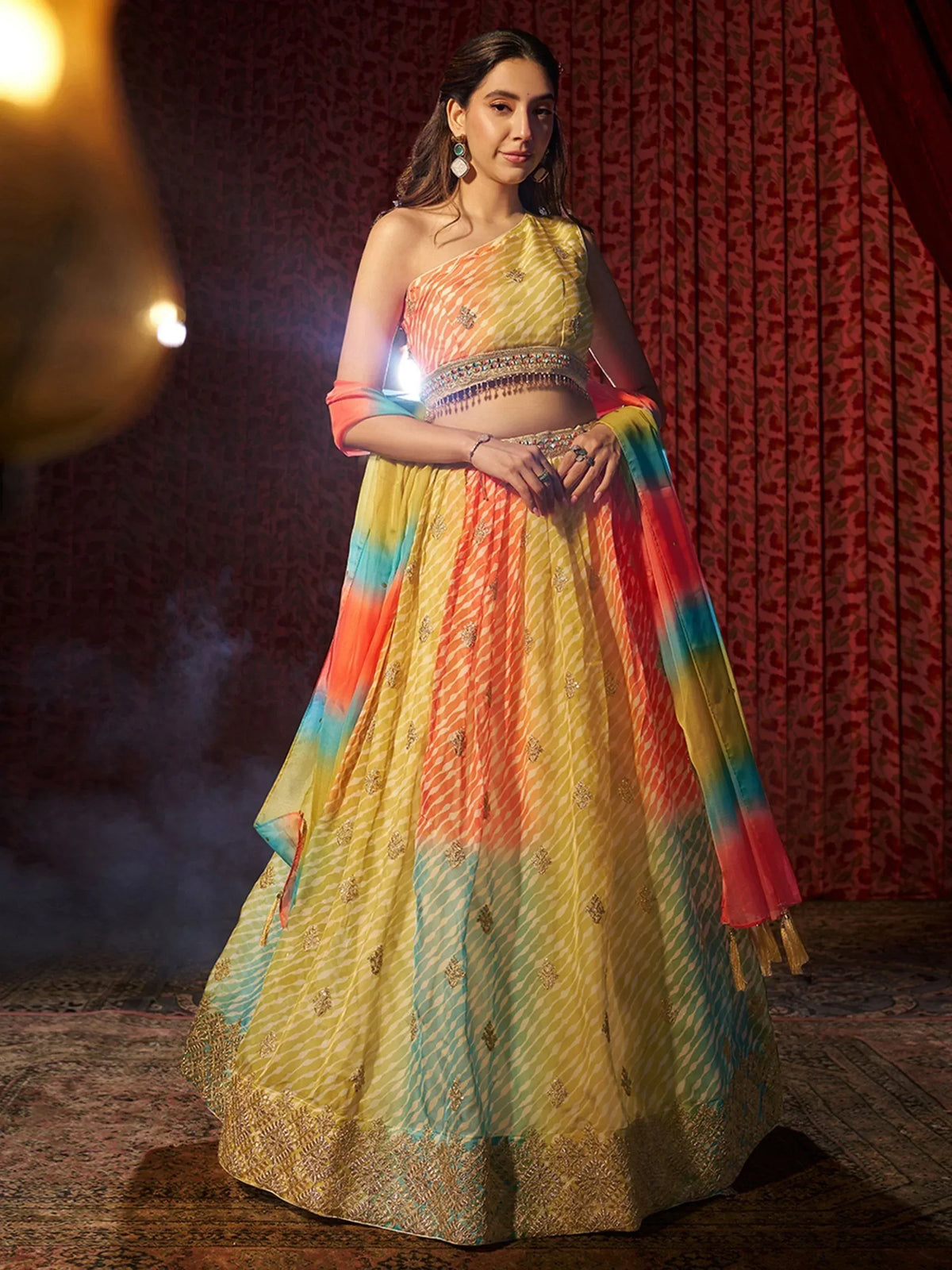 Rainbow tie-dye lehenga choli with gold embroidery, perfect for Indian ethnic wear events