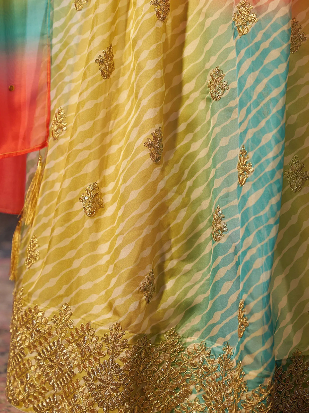 Colorful ethnic gown with gold embroidery and zebra print, perfect for Indian festive wear