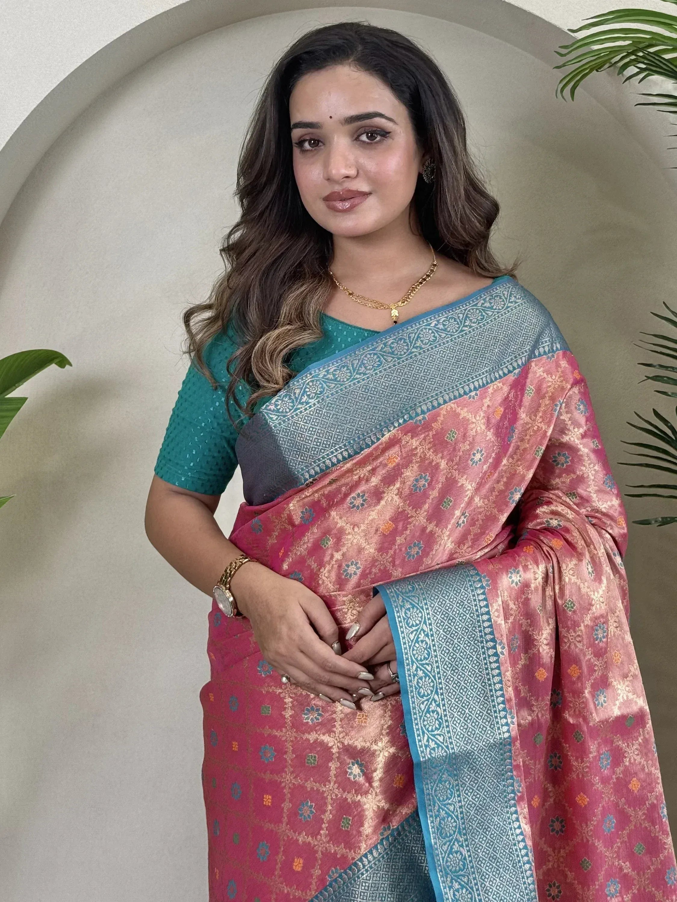 Woman in pink and blue designer saree with floral pattern, ethnic wear for festive occasions
