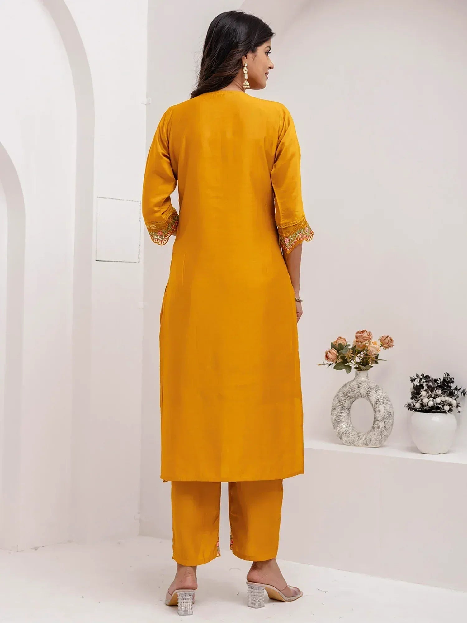 Mustard yellow ethnic kurta with floral embroidery on sleeves and pants, styled for Indian wear